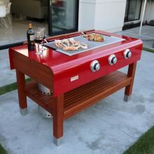 Rockwell By Caliber 60-Inch Freestanding Propane Gas Grill On Wood Table - Red image
