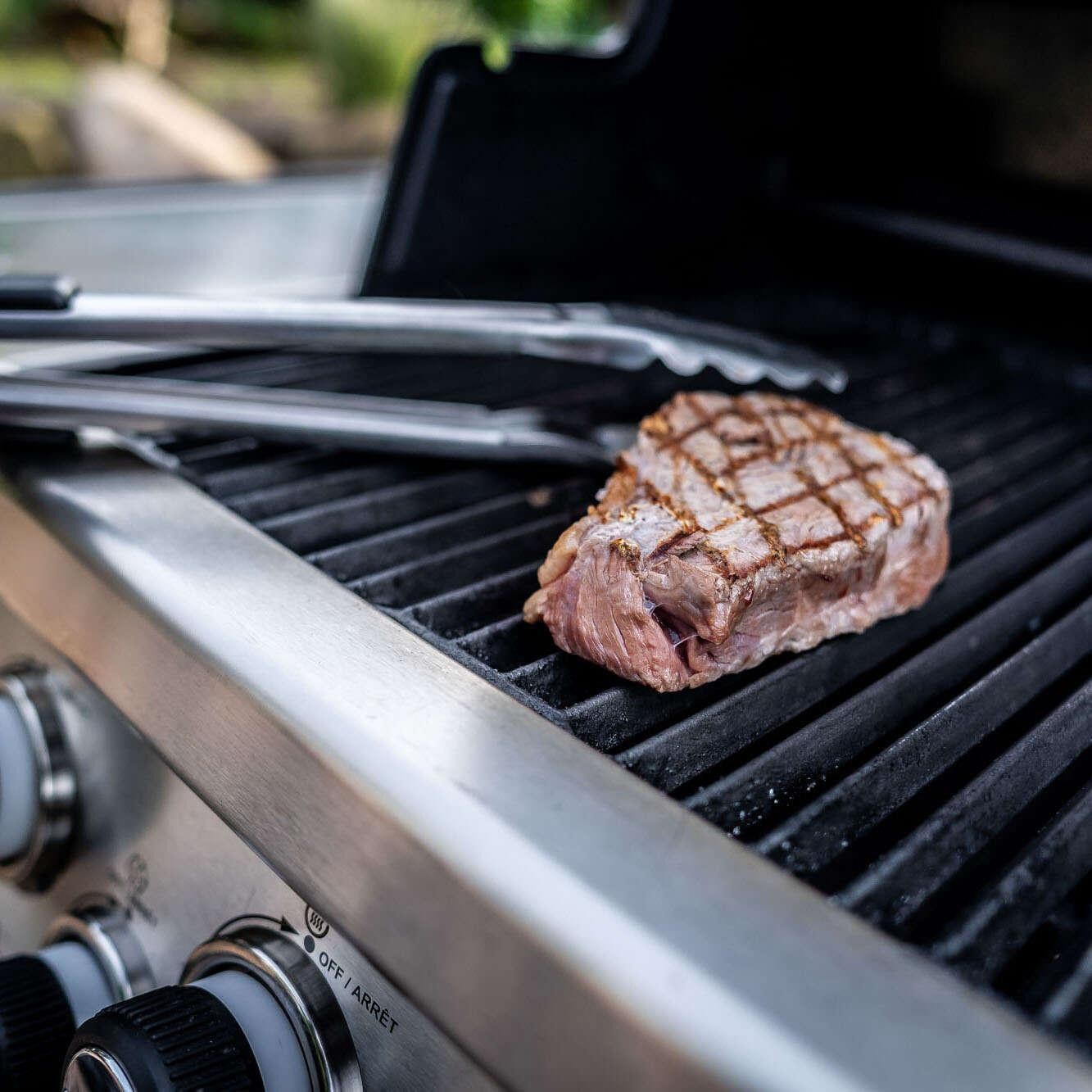 Broil King Stainless Steel Imperial Tongs - 64112 - Grabbing Steak - Lifestyle thumbnail