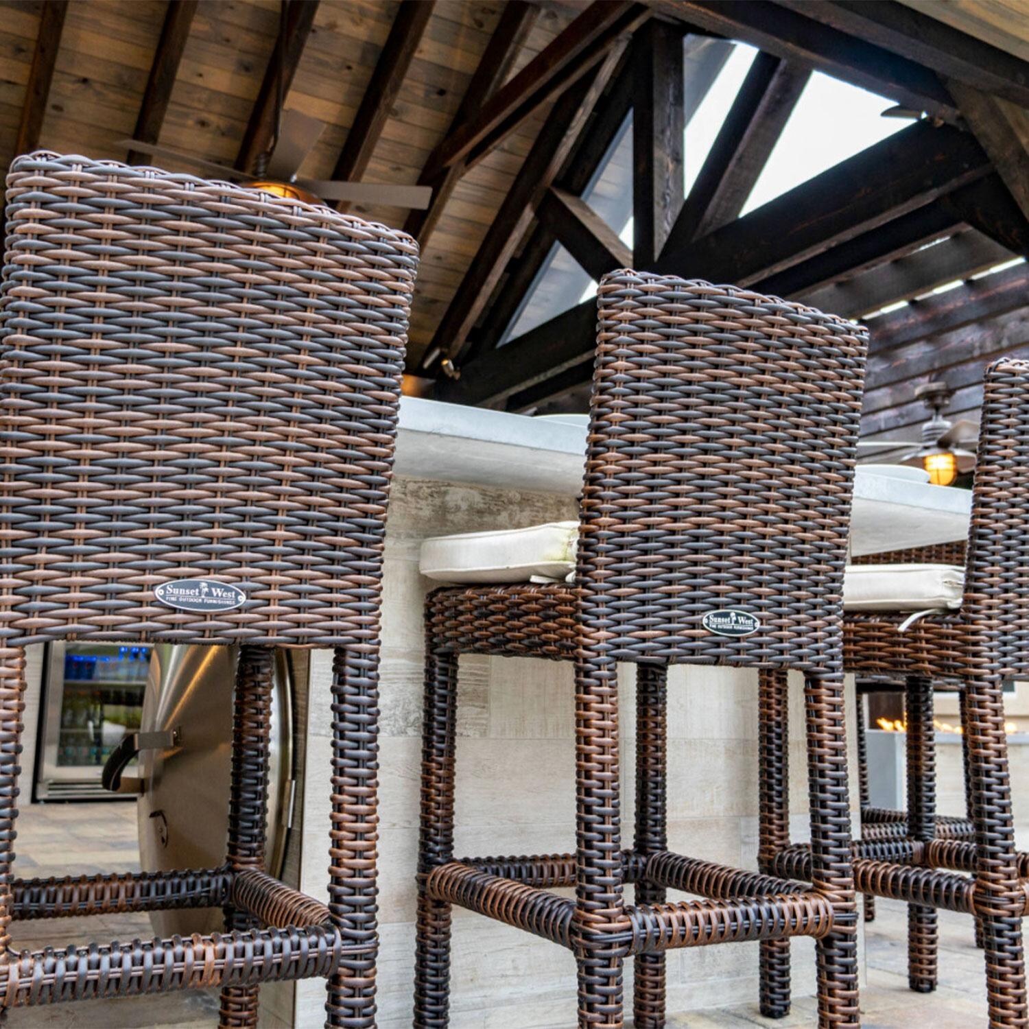 Montecito Wicker Patio Counter Height Bar Stool W/ Sunbrella Canvas Flax Cushion By Sunset West - Bar Setting - Lifestyle thumbnail