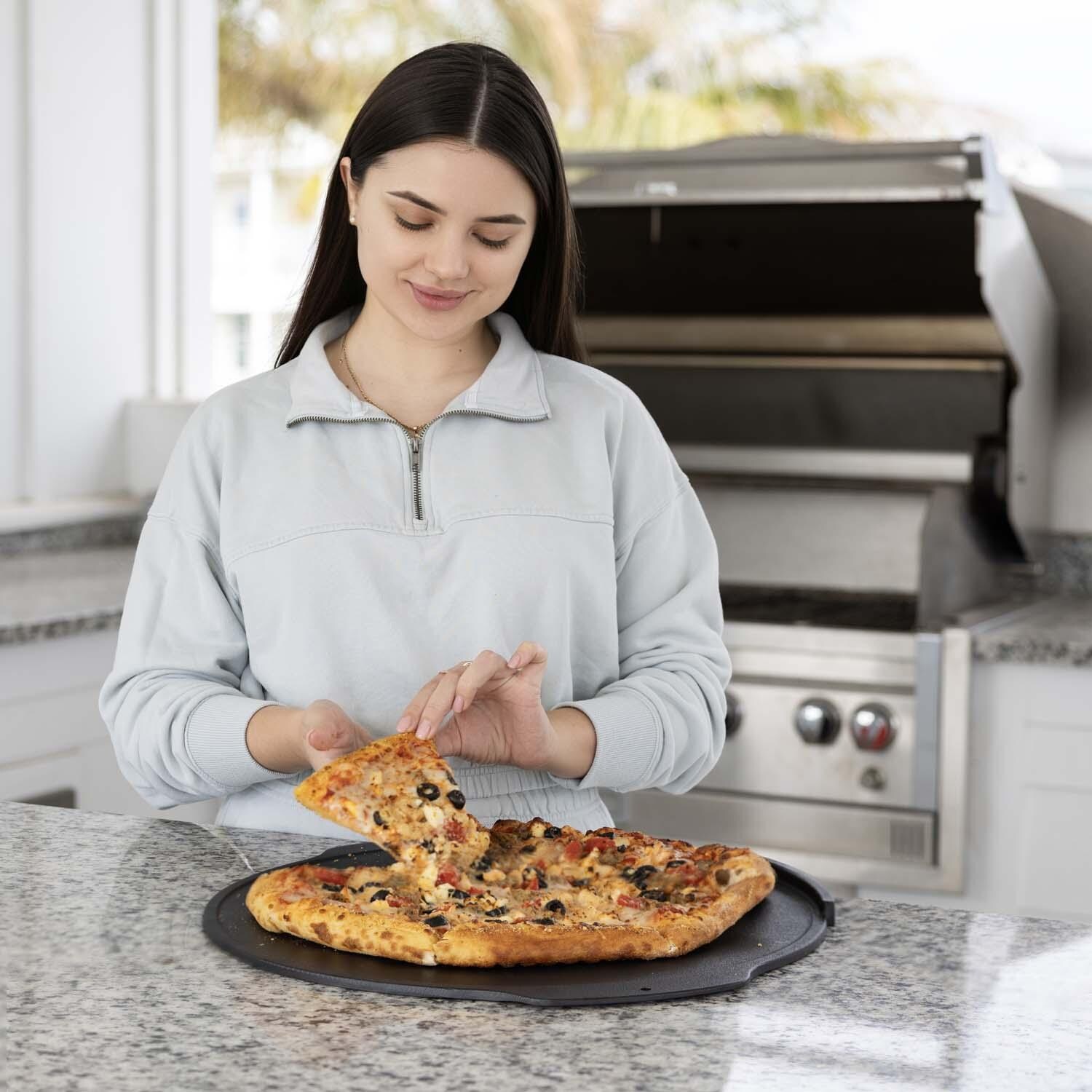 Outset 76597 Cast Iron Pizza Skillet Round - Eating Pizza - Lifestyle thumbnail