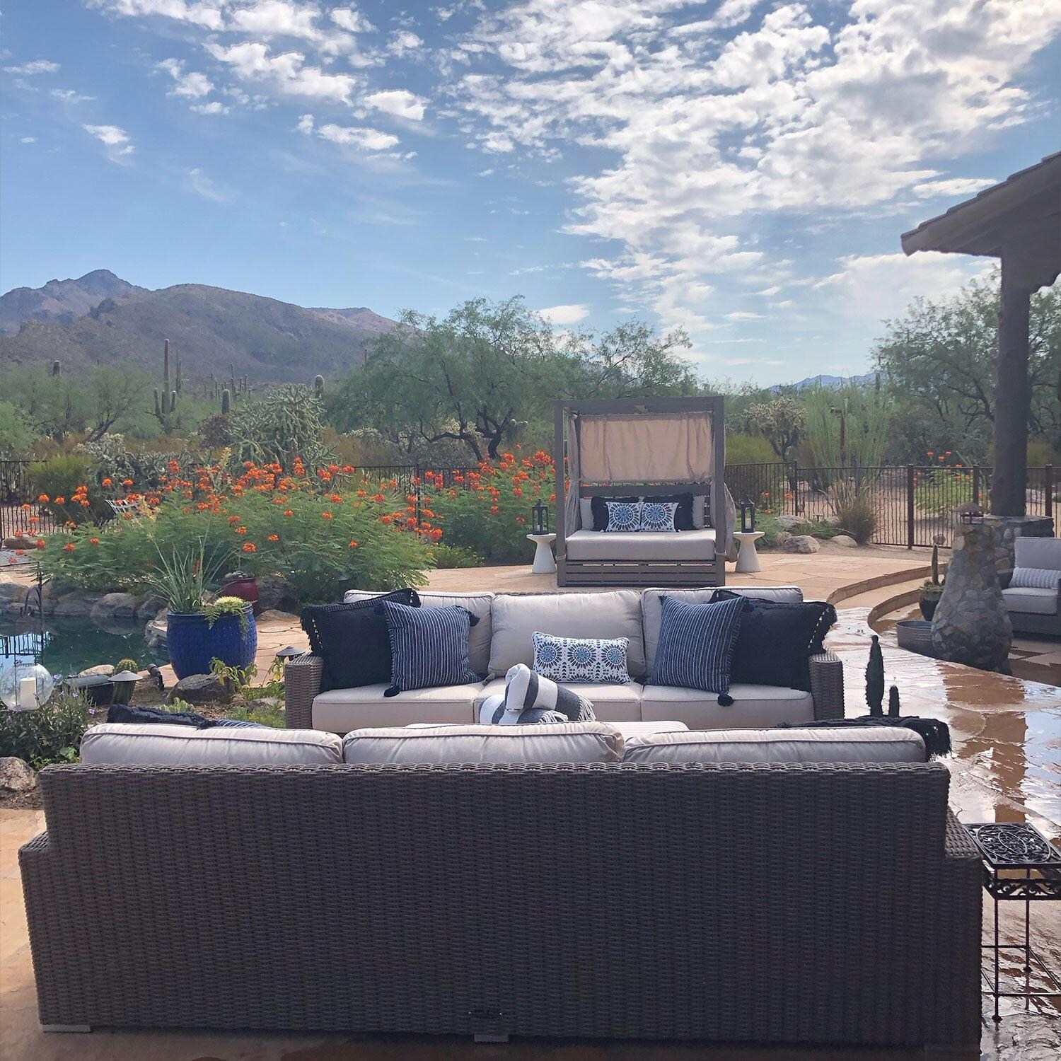 Coronado Wicker Patio Sofa W/ Sunbrella Canvas Flax Cushions By Sunset West - Rear View - On Patio - Lifestyle thumbnail