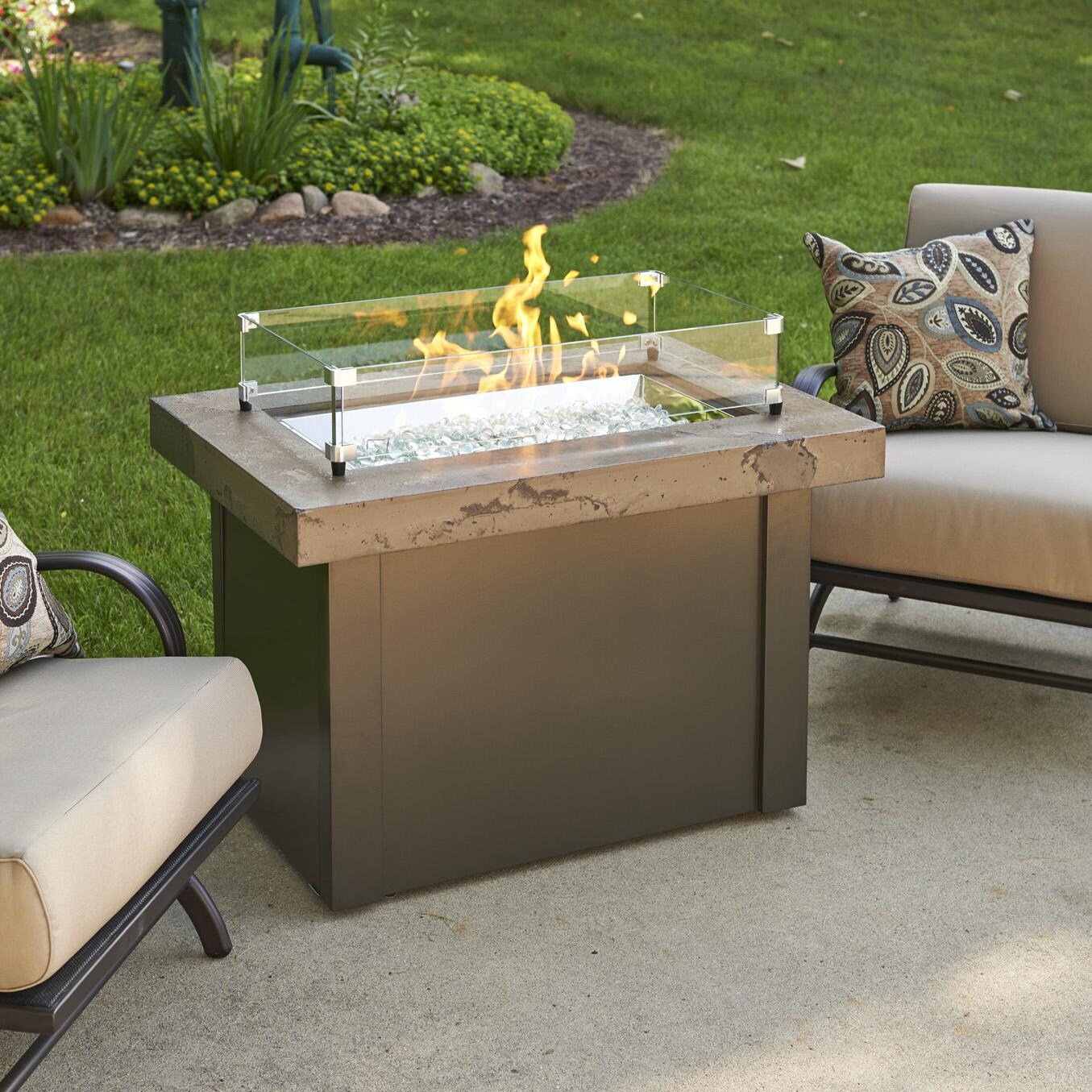 The Outdoor GreatRoom Company Providence Rectangular Gas Fire Pit Table - Brown - Lifestyle - Glass wind guard pictured is optional accessory thumbnail