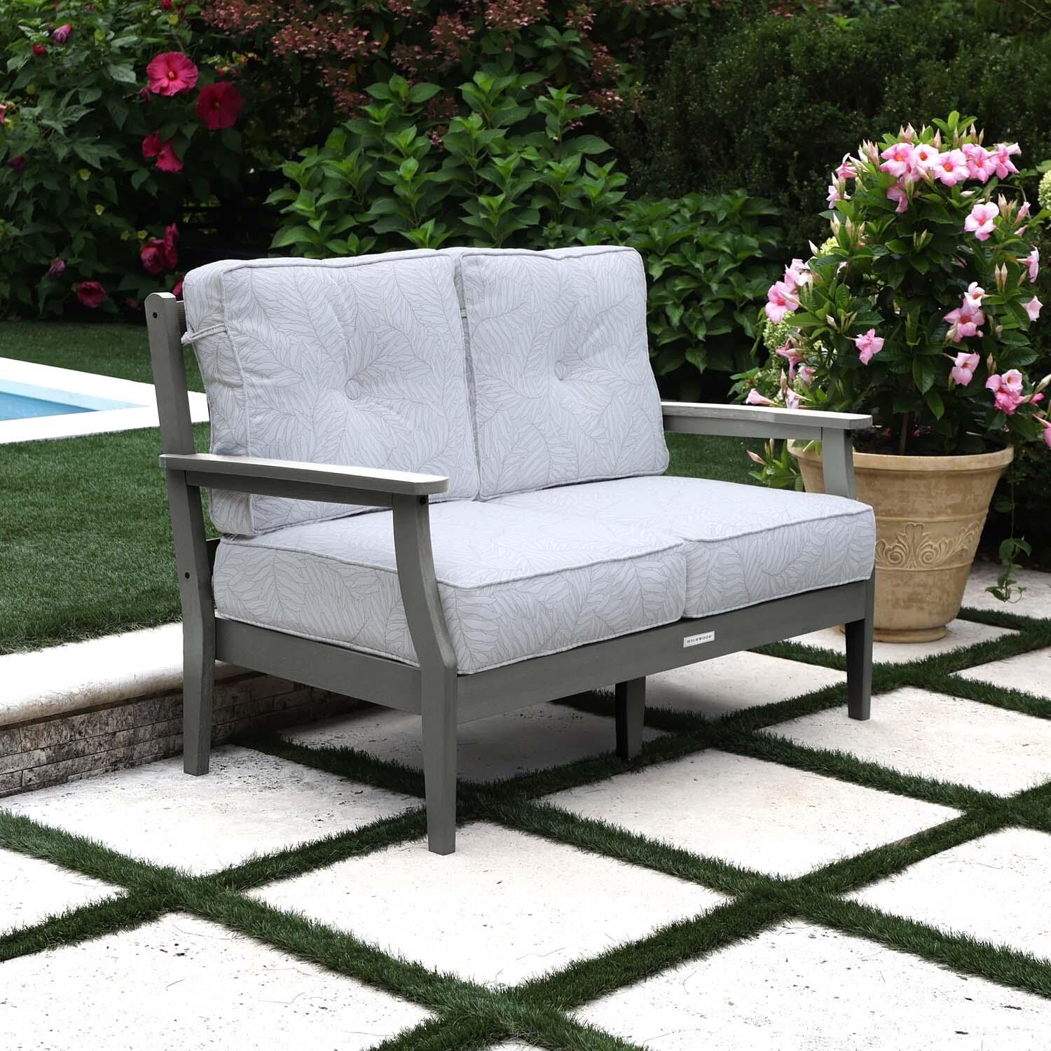 Blushing Bay 2 Person Recycled Plastic Loveseat in Lively Parchment/Coastal Teak by Lakeview Outdoor Designs - Left Angled - Lifestyle thumbnail