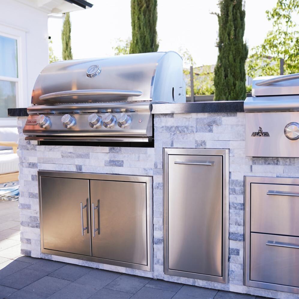 BBQGuys Signature 8 Ft Grill Island w/ 32 Inch Natural Gas Blaze Premium LTE+ Grill & Griddle, Narrow Trash Bin & Door & Drawer | Alaska Gray w/ Black Granite - Angle - Lifestyle thumbnail