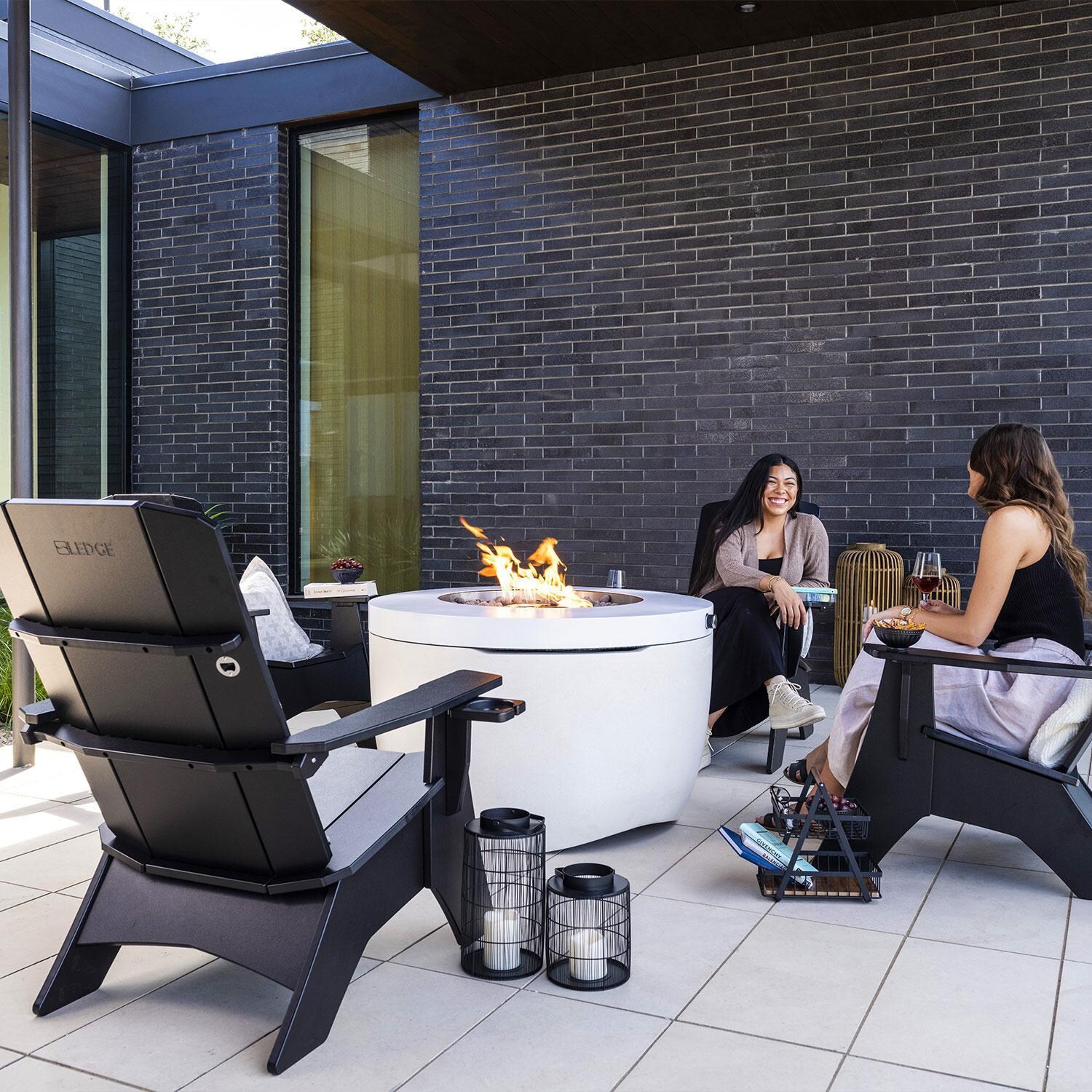 Halo LL-FL-FP-PR-RD40-SNS 40-in Round Powder Coated Steel Propane Fire Pit in Sunset by Ledge Lounger - Friends by Fire - Shown in Moonrise finish - Lifestyle thumbnail