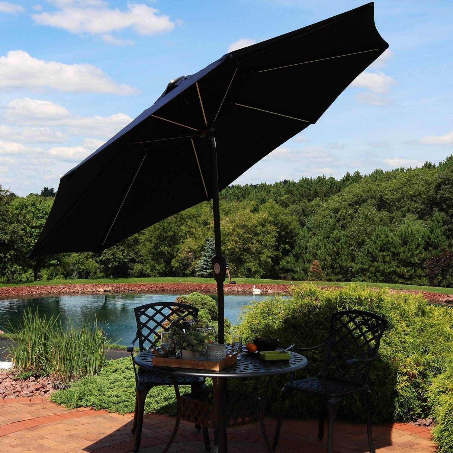 Ultimate Patio 9 Ft. Solar Lighted Patio Umbrella W/ Crank & Tilt - Navy Blue - Tilted Lifestyle View thumbnail