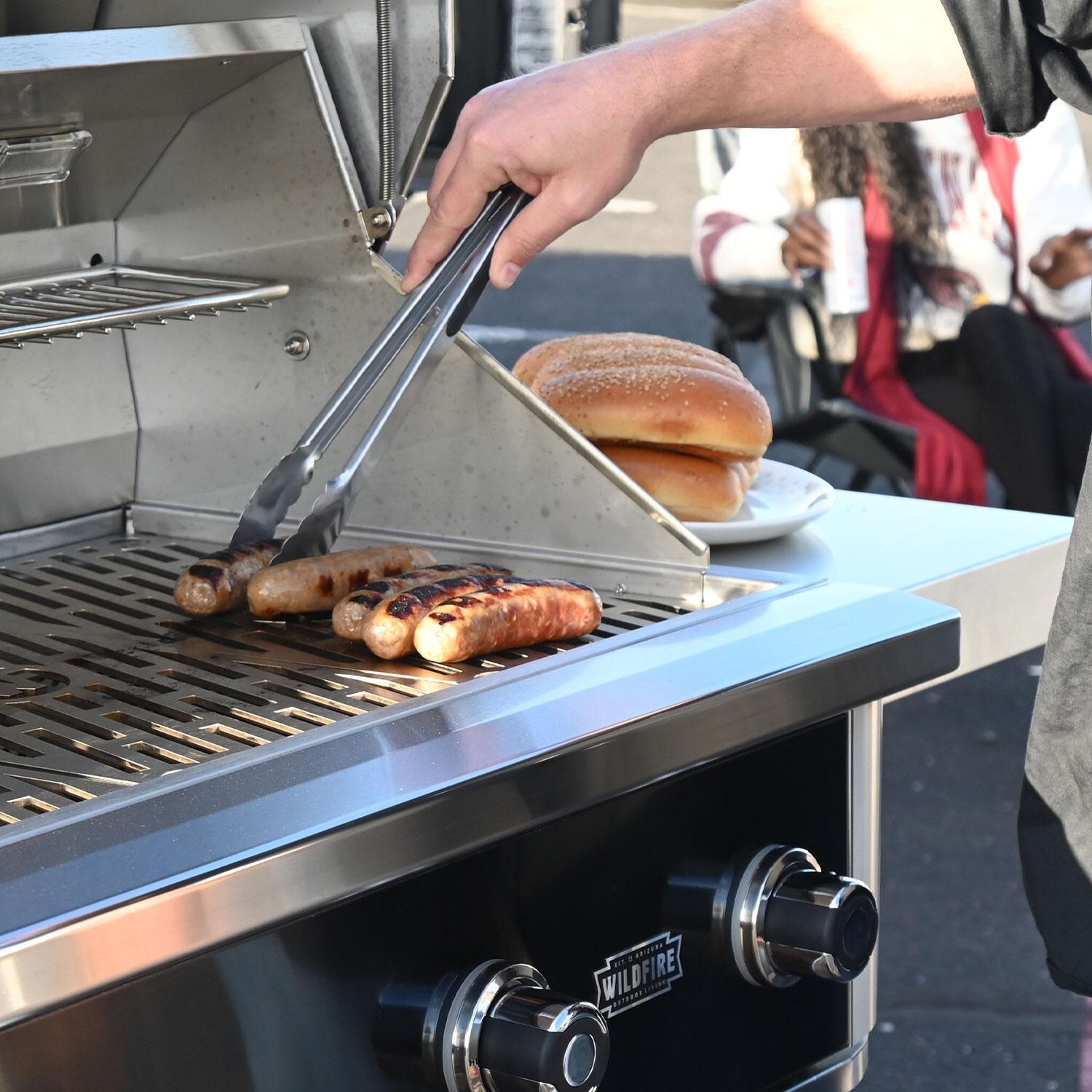 Wildfire Ranch Pro 42-in 304 SS Propane Grill w/ Freestanding Cart - Grilling Hot Dogs - Shown on Black finish Grill - Lifestyle thumbnail