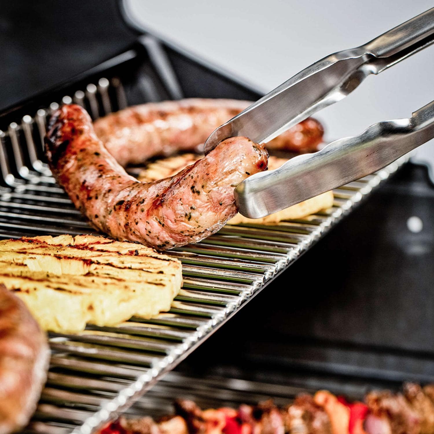 Broil King 687247 Regal Q 490 Pro IR Natural Gas Grill - Cooking on Warming Rack - Lifestyle thumbnail