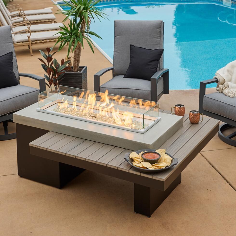 Lakeview Outdoor Designs Emfield 65 Inch Rectangular Aluminum Natural Gas w/ Electronic Ignition Fire Pit Table in Coastal Grey (Ships as Propane w/ Conversion Kit) - By the Pool w/ Flame Glass - Lifestyle thumbnail