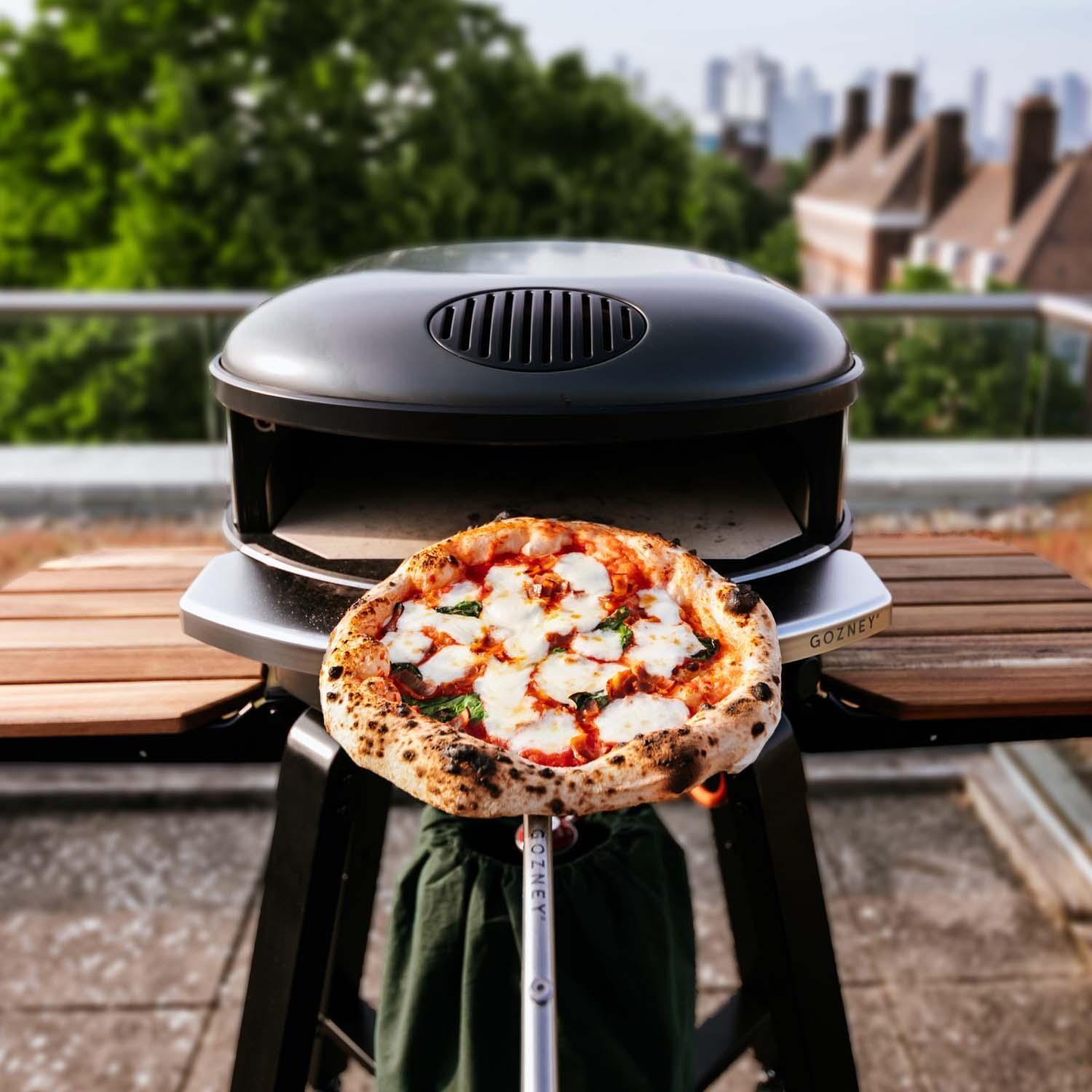 Gozney GAPOBUS1624 Black Arc XL Propane Pizza Oven Essentials Bundle - Pizza on Peel - Lifestyle thumbnail