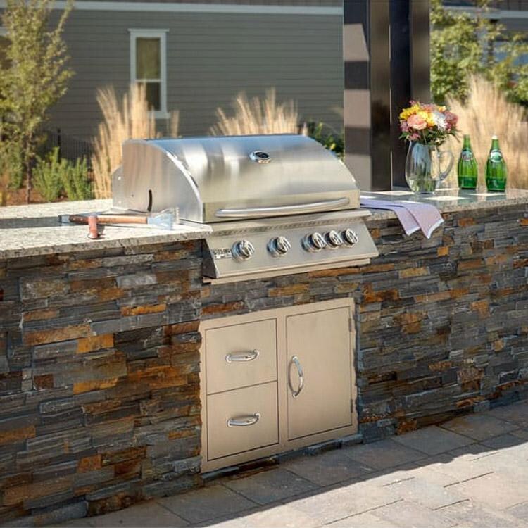 Grillnetics Adjustable Easy Outdoor Kitchen Frame Kit - Lifestyle View With Stone Finished Grill Cabinet & Storage Door & Drawer Combo thumbnail