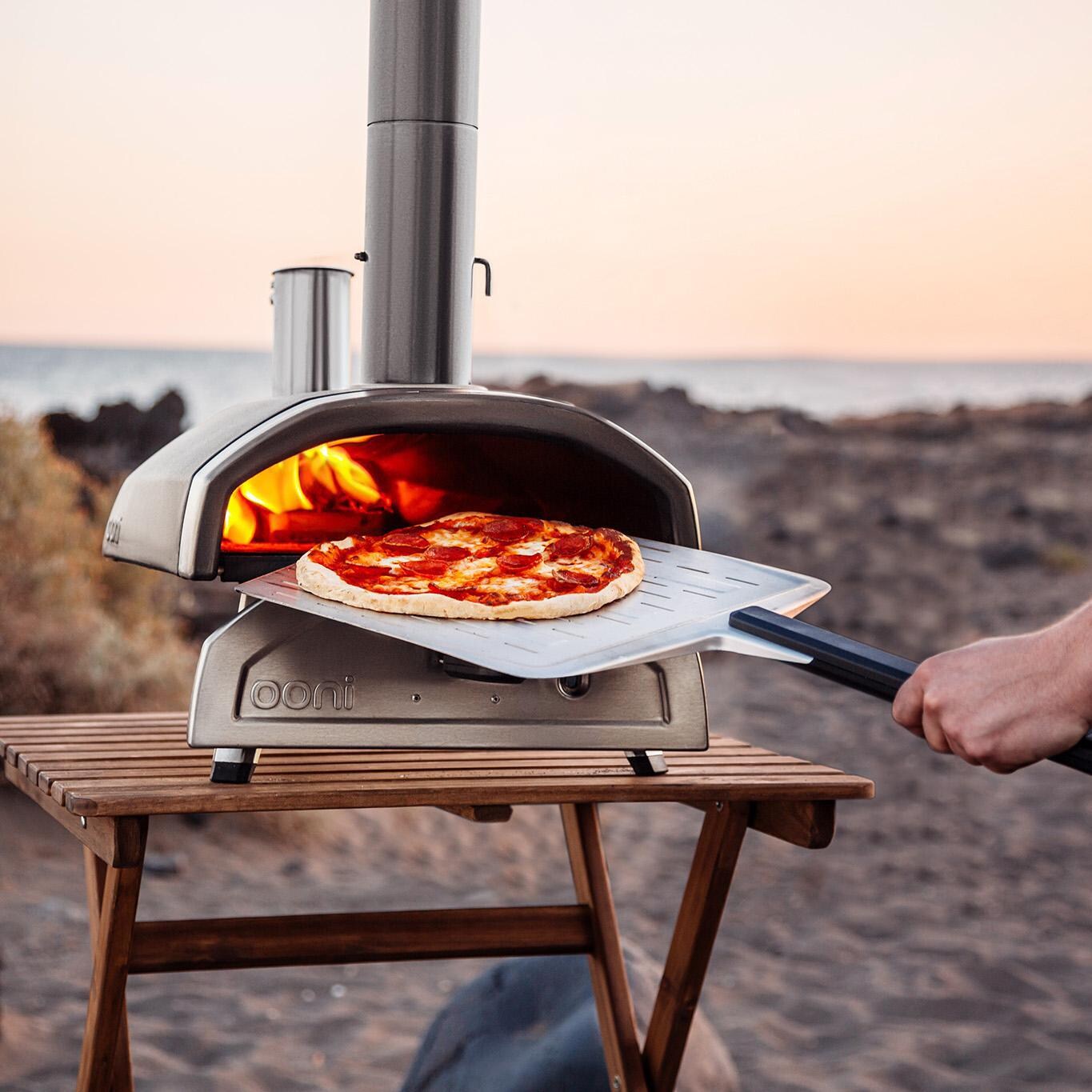 Ooni - UU-P0AD00 - Fyra 12 Wood Pellet Portable Outdoor Pizza Oven - Cooking A Pizza On The Beach thumbnail