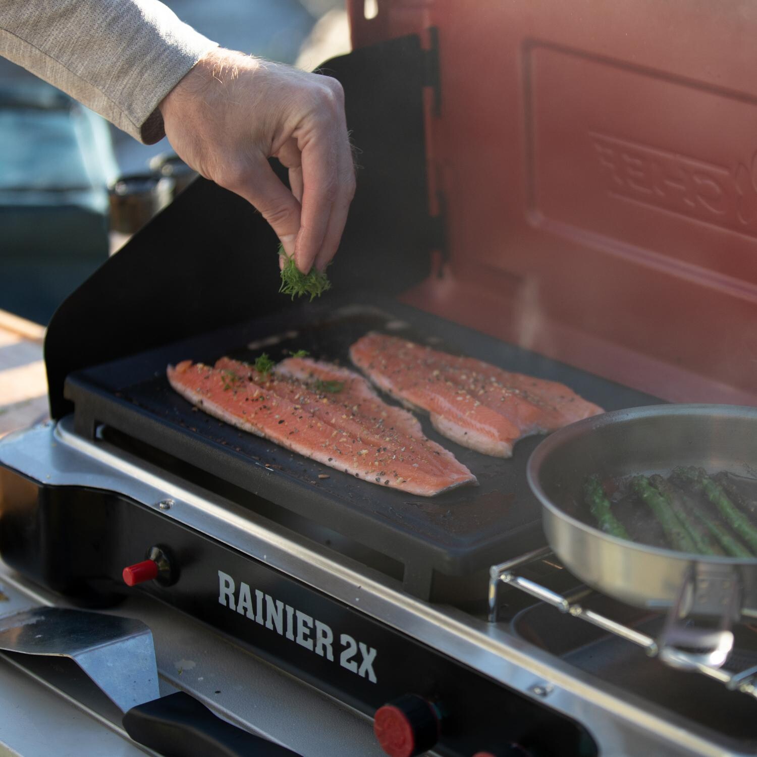 Camp Chef MSGGX Mountain Series Rainier 2X 2-Burner Cooking System w/ Griddle & Carry Bag - Cooking Fish thumbnail