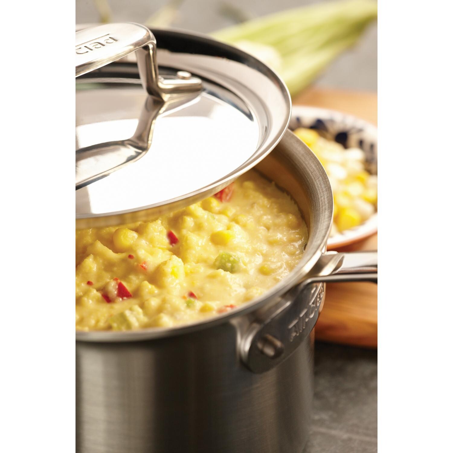 All-Clad D5 Stainless 3-Quart Sauce Pan With Loop And Lid In Use thumbnail