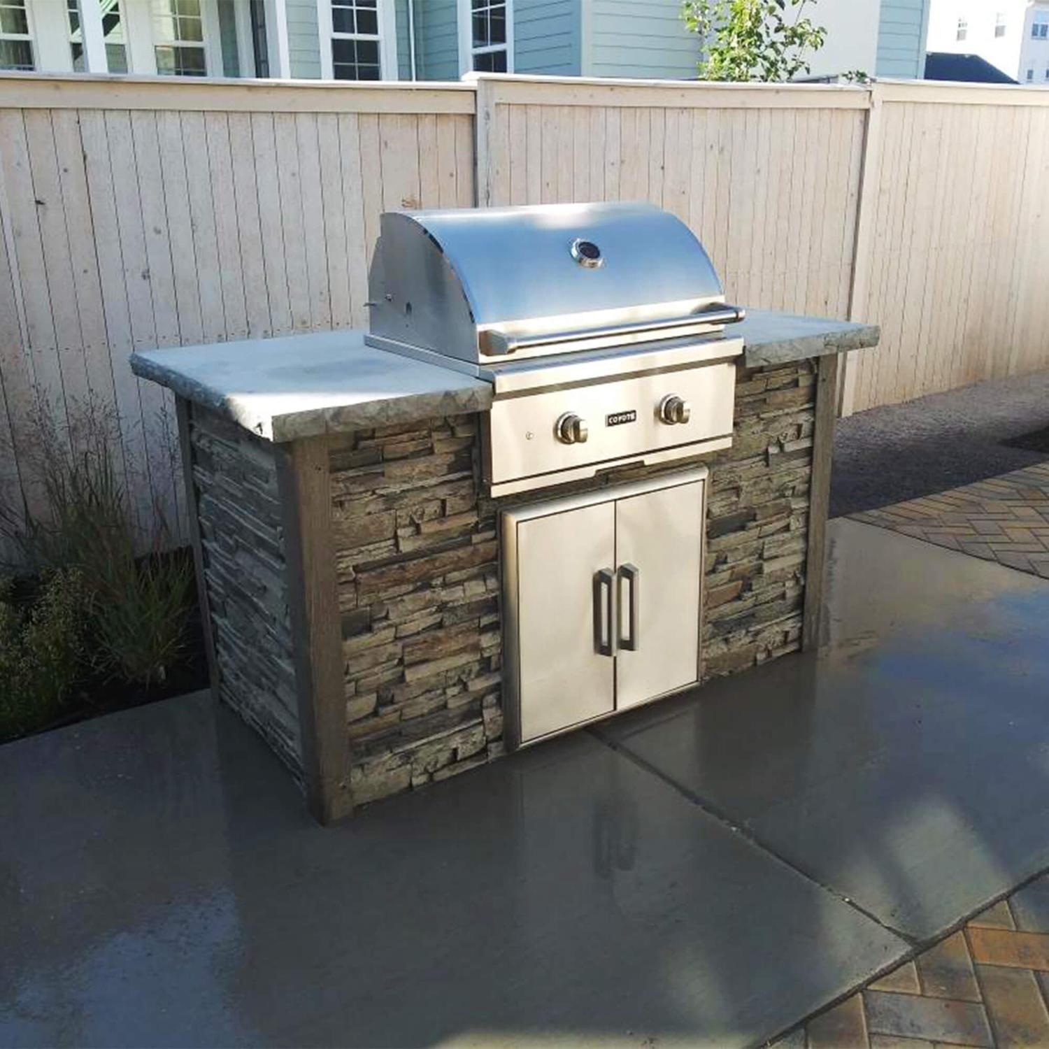 Coyote RTAC-G5-SG-C1C28LP Ready-To-Assemble 5 Ft Outdoor Kitchen Island With 28-Inch C-Series Propane Gas Grill - Stacked Stone/Stone Gray - Lifestyle View thumbnail
