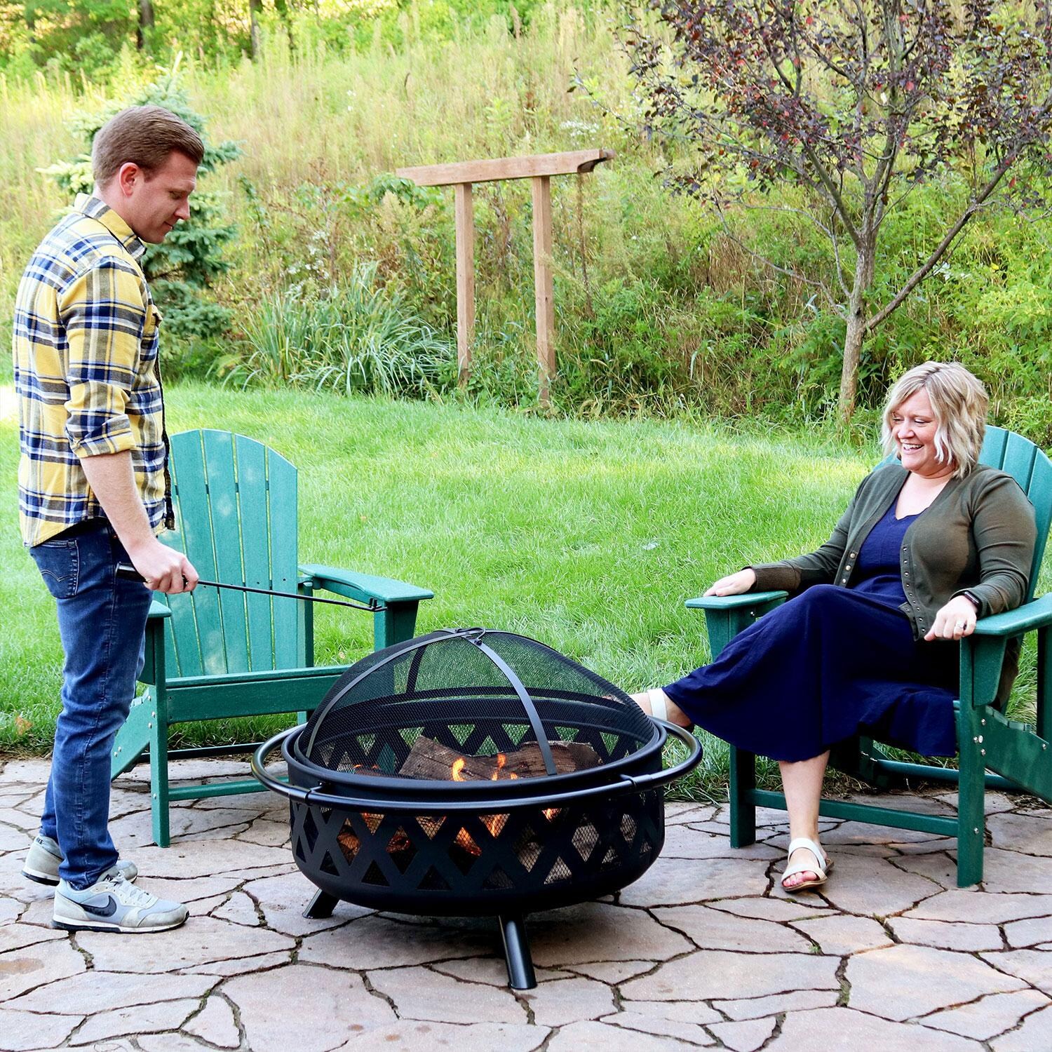 Ultimate Patio Crossweave 36 Inch Round Steel Wood-Burning Fire Pit in Black - Tending The Fire Alternate - Lifestyle thumbnail