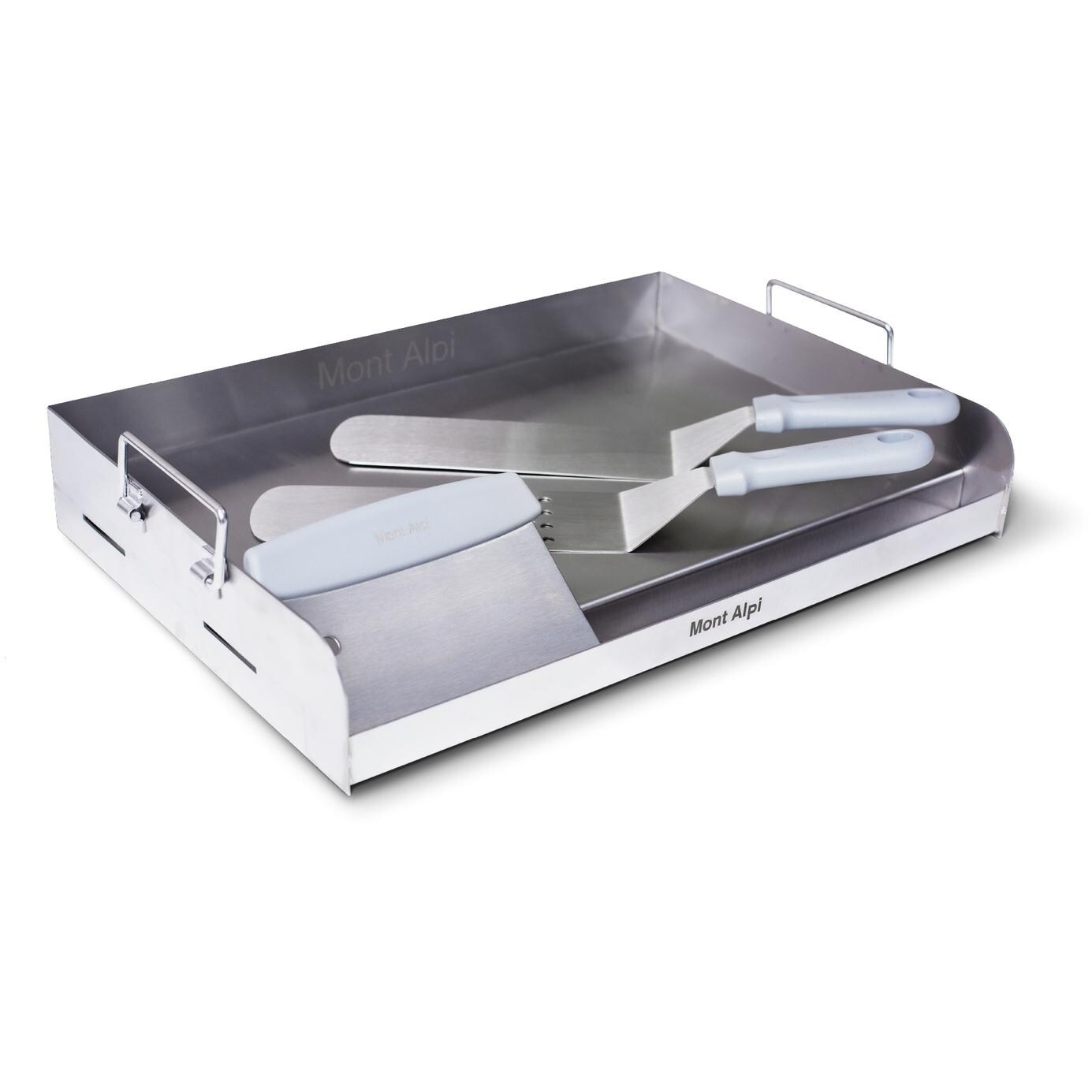 Spatulas and scraper resting on griddle plate thumbnail
