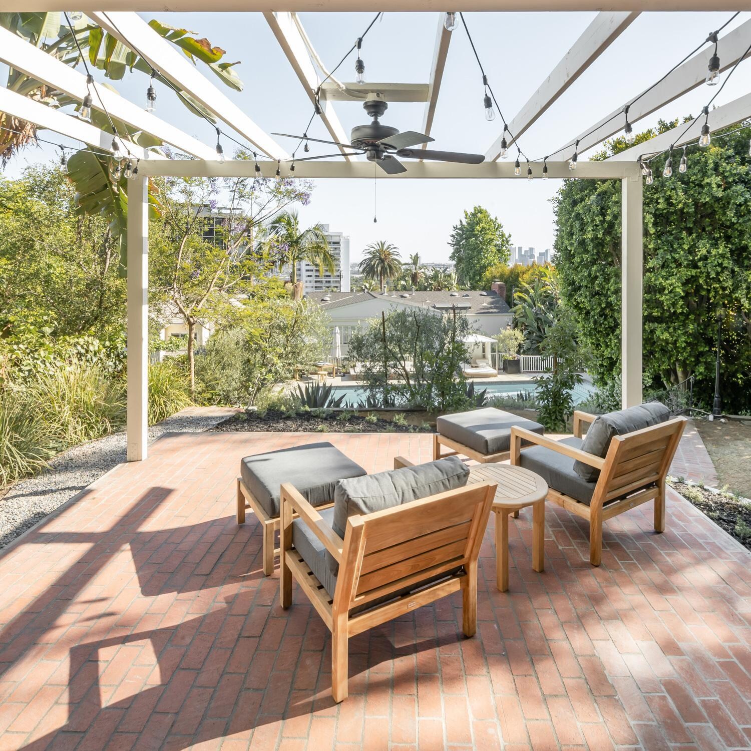 Teak + Table Monday Teak Patio Ottoman in Natural - Rooftop Patio - Lifestyle thumbnail