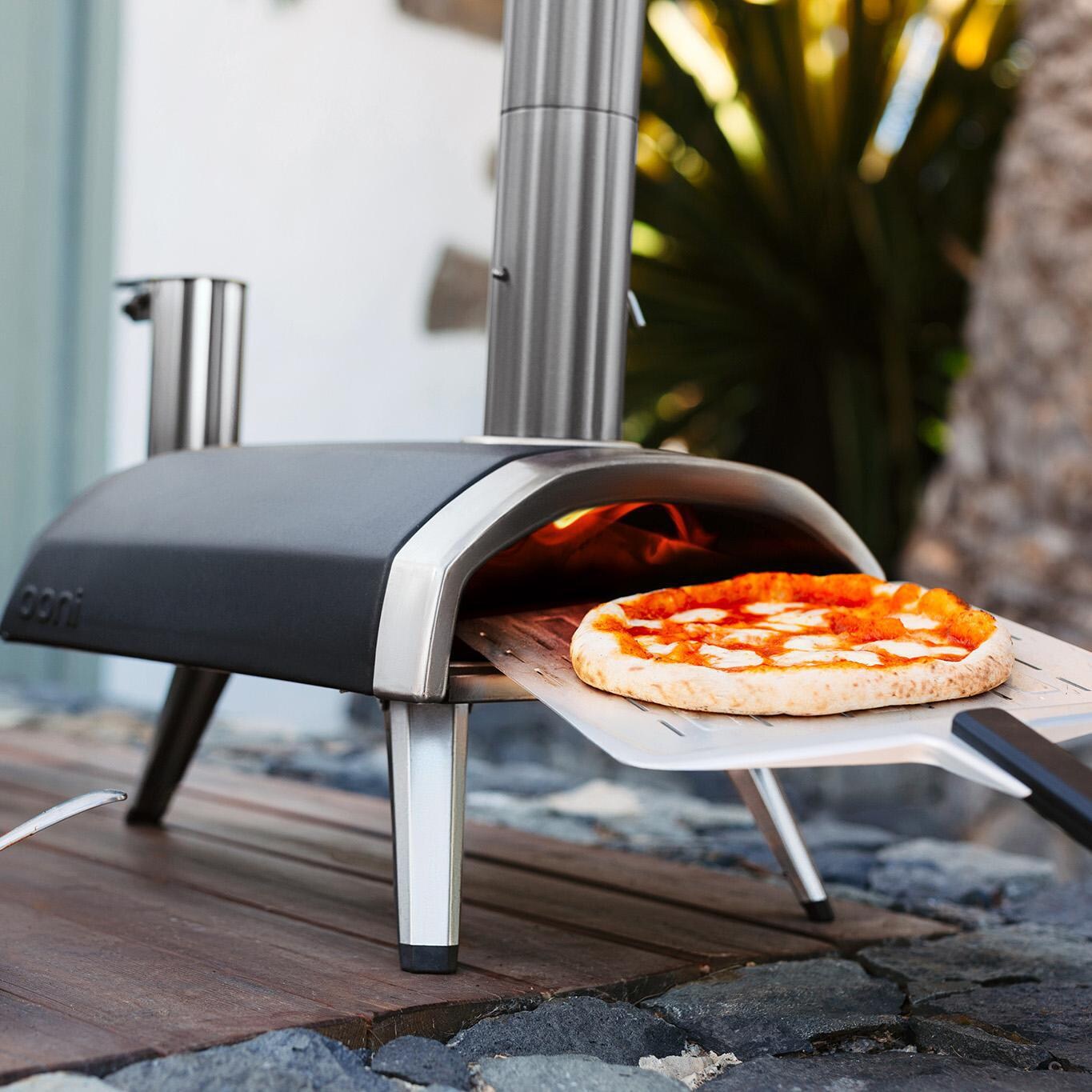 Ooni - UU-P0AD00 - Fyra 12 Wood Pellet Portable Outdoor Pizza Oven - Putting In A Pizza thumbnail