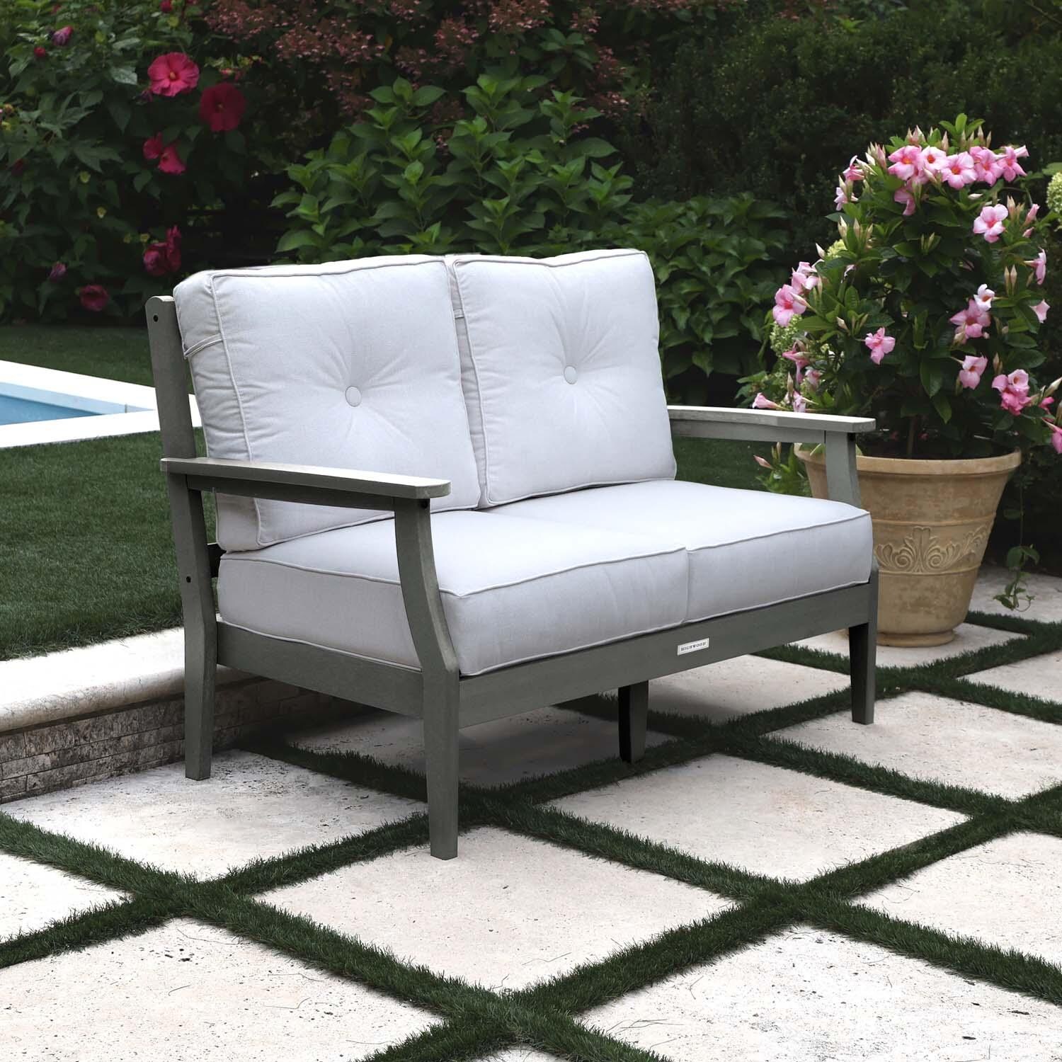 Blushing Bay 2 Person Recycled Plastic Loveseat in Bliss Linen/Coastal Teak by Lakeview Outdoor Designs - Left Angled - Lifestyle thumbnail
