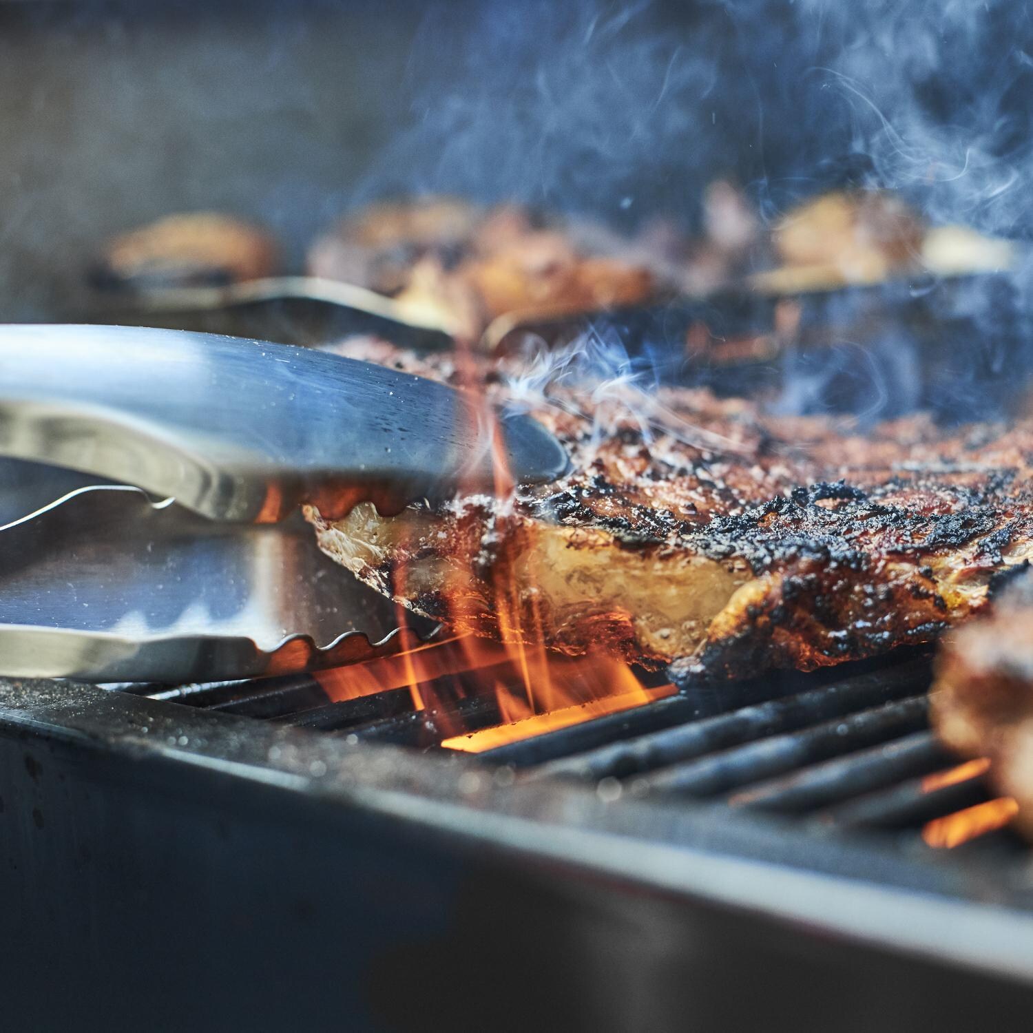 Weber 22510201 SmokeFire EX4 Gen 2 24-Inch Wi-Fi Enabled Wood Fired Pellet Grill - Grilling Steak - Lifestyle thumbnail