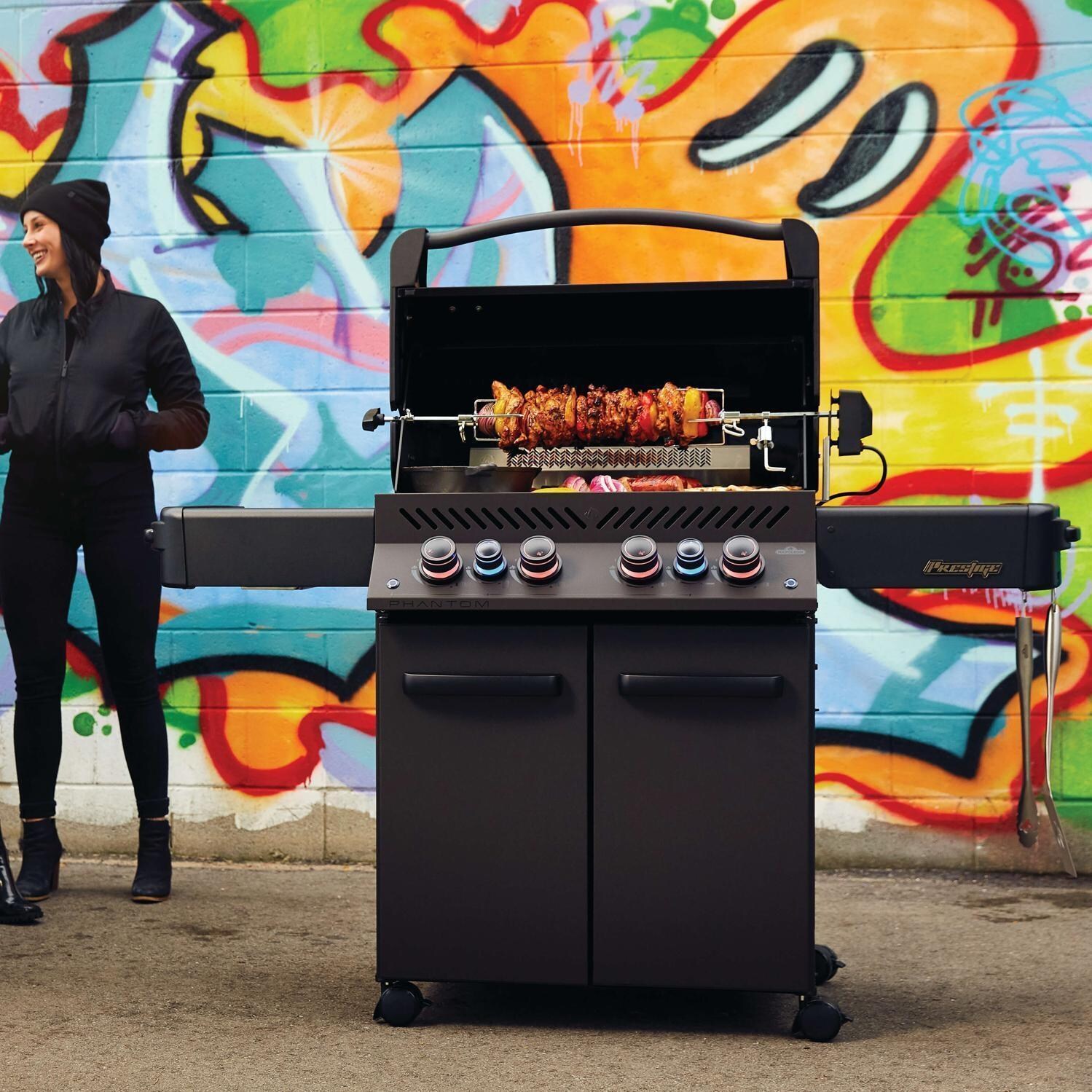 Napoleon Phantom Prestige 500 Propane Grill Bundle w/Cover, Charcoal Tray, Rotisserie Basket & Drip Trays - Phantom Prestige 500 Propane Grill - Using Rotisserie - Lifestyle thumbnail