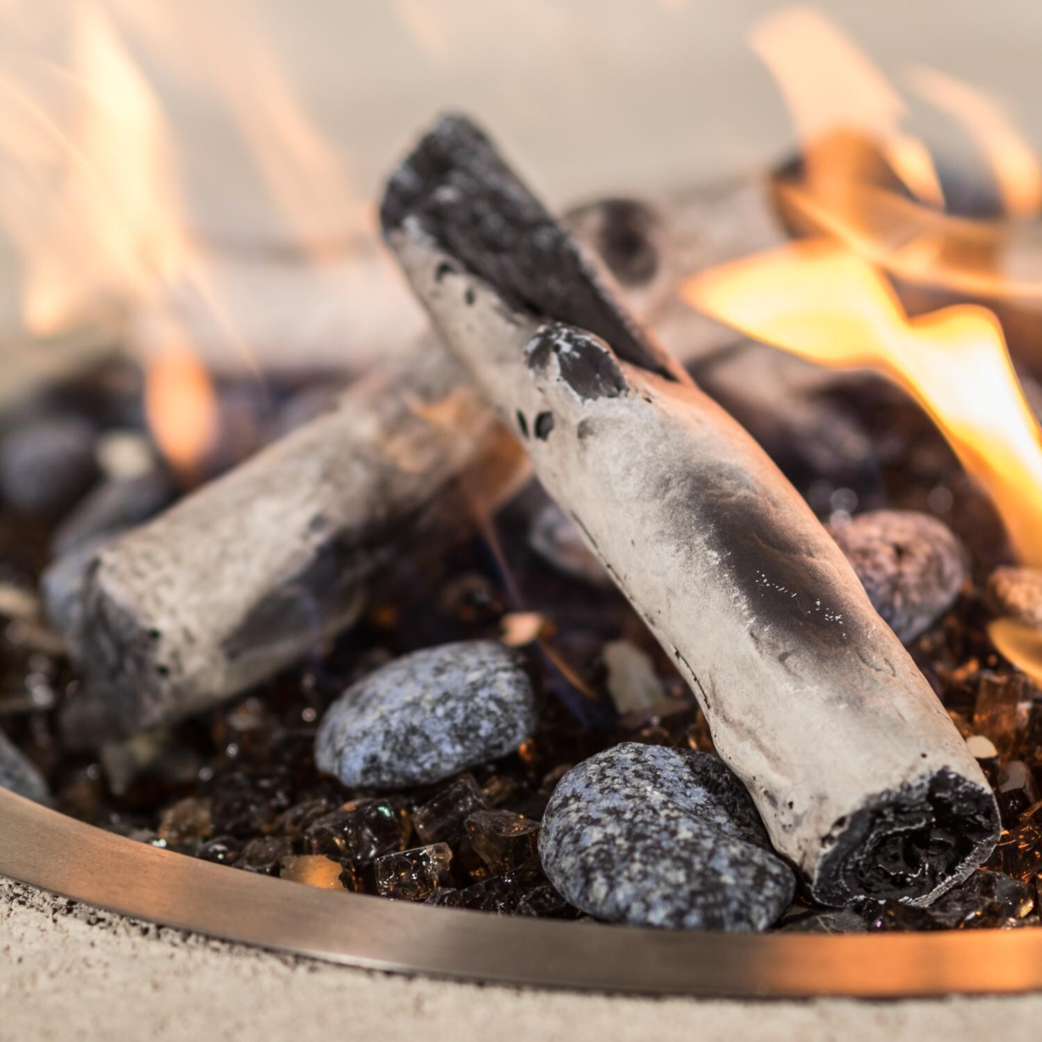 BBQGuys Signature Series Round Drop-In Pan W/ Ring Burner - Lit - Shown W/ BBQGuys Signature Series Roman Bronze Reflective Fire Glass, Enhance a Fire Lighthouse Path Mixed Stones, and Enhance a Fire Key Largo Twigs (Fire Media Sold Separately) thumbnail