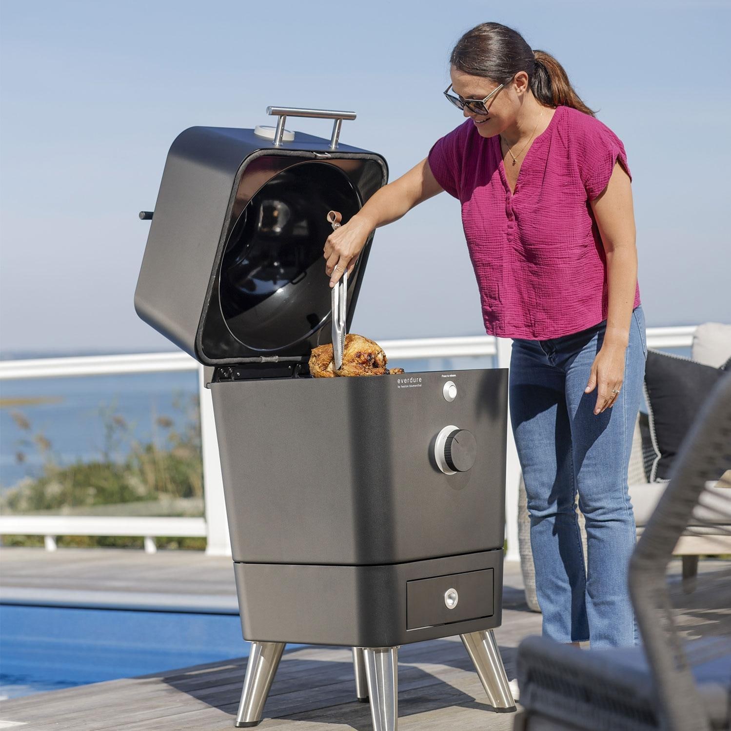 Everdure EKAMK1B 18 Inch Cast Aluminum Kamado Grill W/Stand - Cooking Rotisserie On Patio - Lifestyle thumbnail