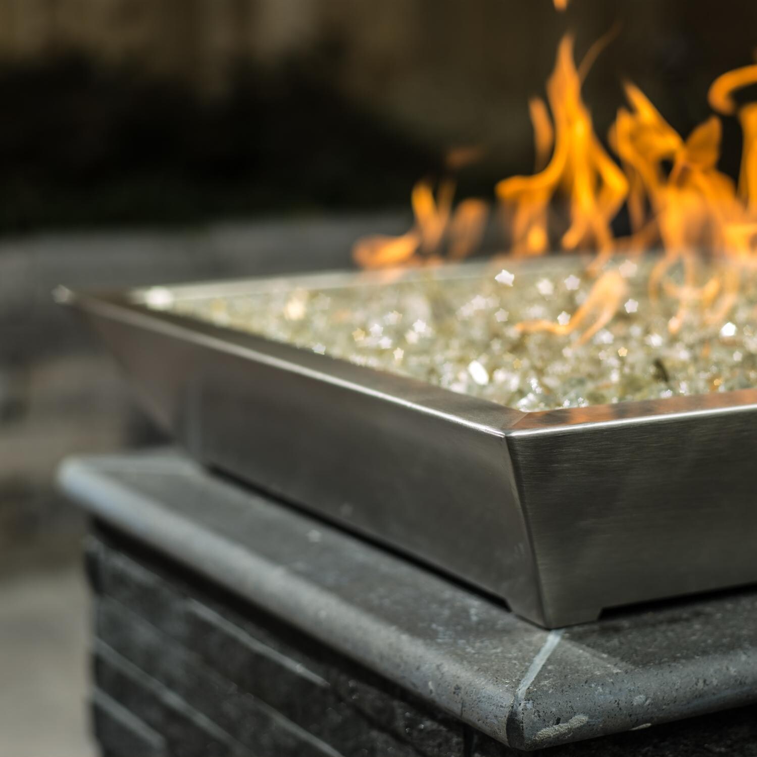 BBQGuys Signature Series Westfalen 24-Inch Square Low-Rise Propane Fire Bowl - Stainless Steel - Side View - Shown with 1/2 inch White Gold Reflective Fire Glass (Sold Separately) thumbnail