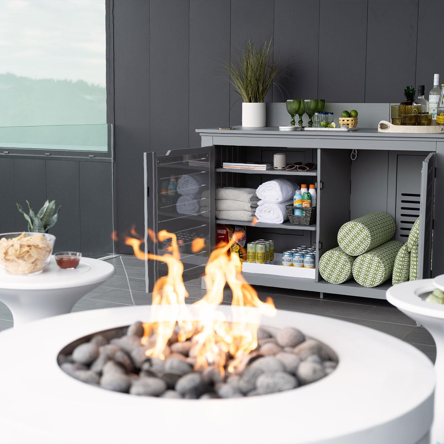 Halo LL-FL-FP-PR-RD40-SNS 40-in Round Powder Coated Steel Propane Fire Pit in Sunset by Ledge Lounger - Under Porch w/ Cleaning Station (Not Included) - Shown in Moonrise finish - Lifestyle thumbnail