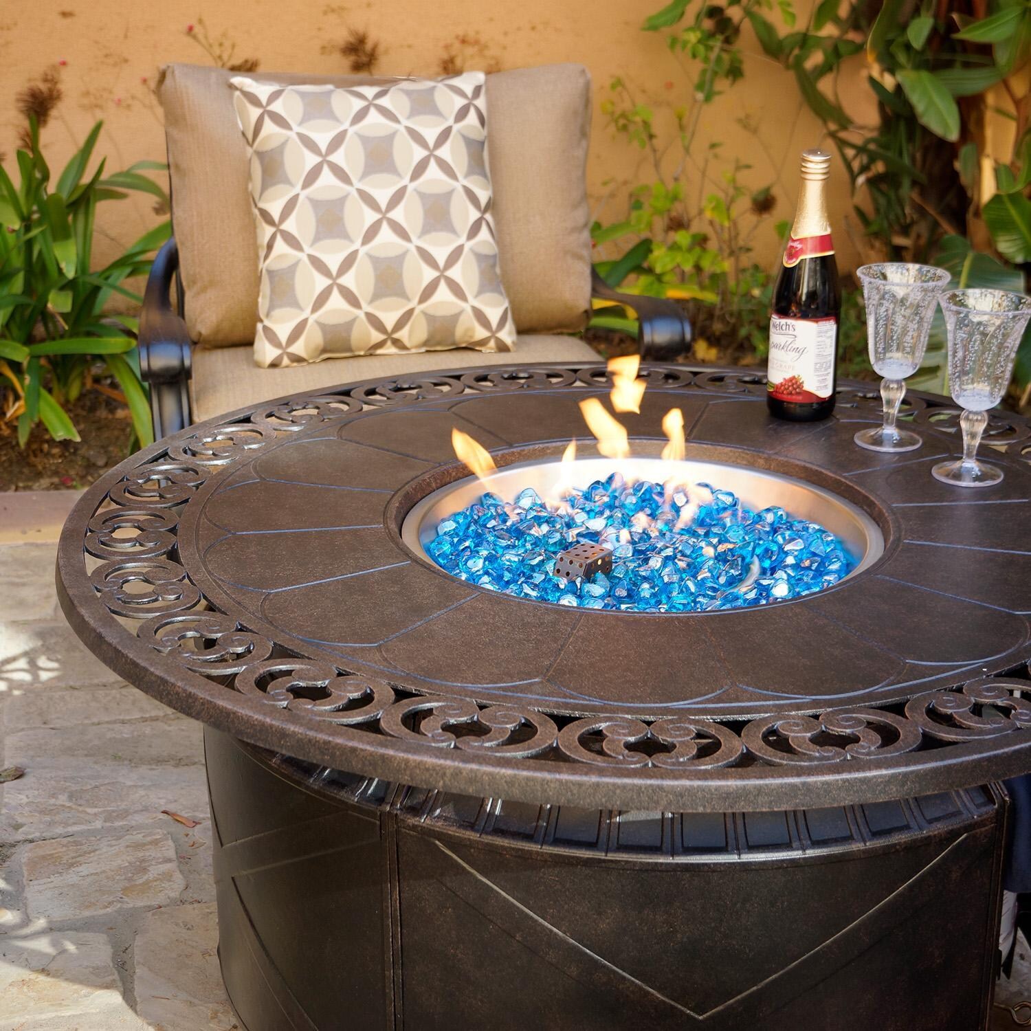 Darlee Elisabeth 5 Pc Cast Aluminum Fire Pit Seating Set w/ 47 Inch Table w/ Club Chairs & Throw Pillows in Antique Bronze/Beige - Table Lit - Lifestyle thumbnail