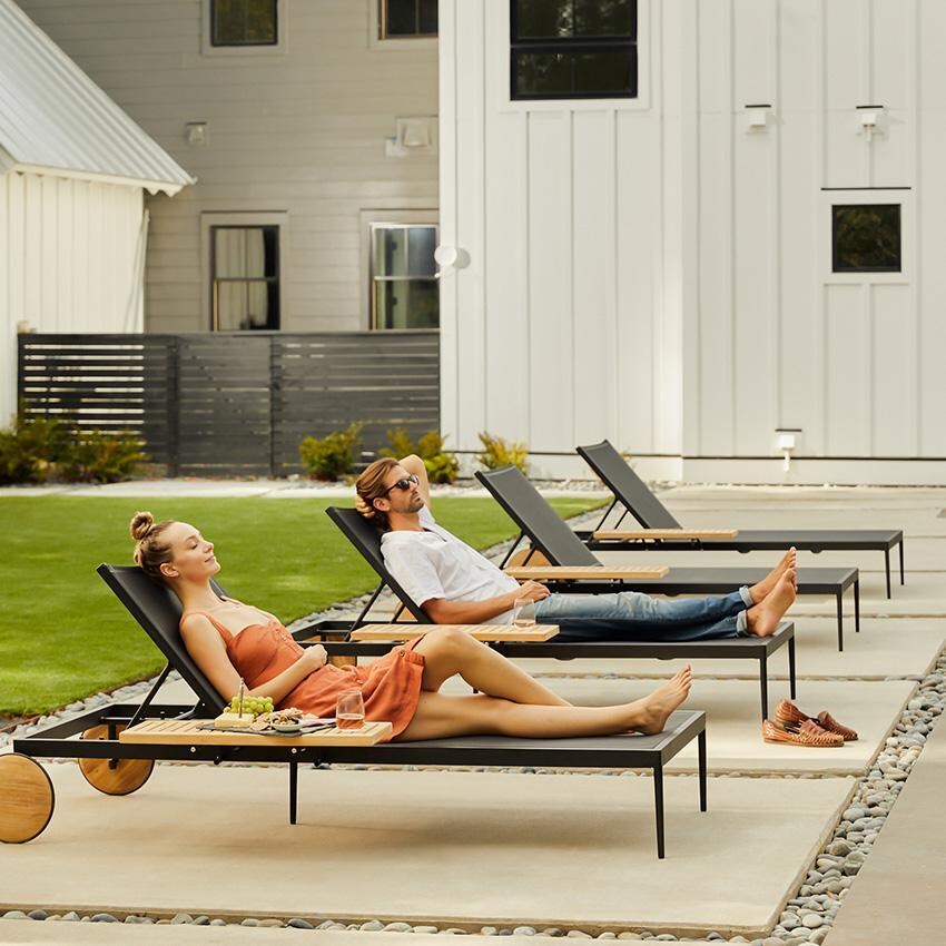 Teak + Table St Barts Aluminum Chaise Lounge in Black - Lounging on Chaise - Lifestyle thumbnail