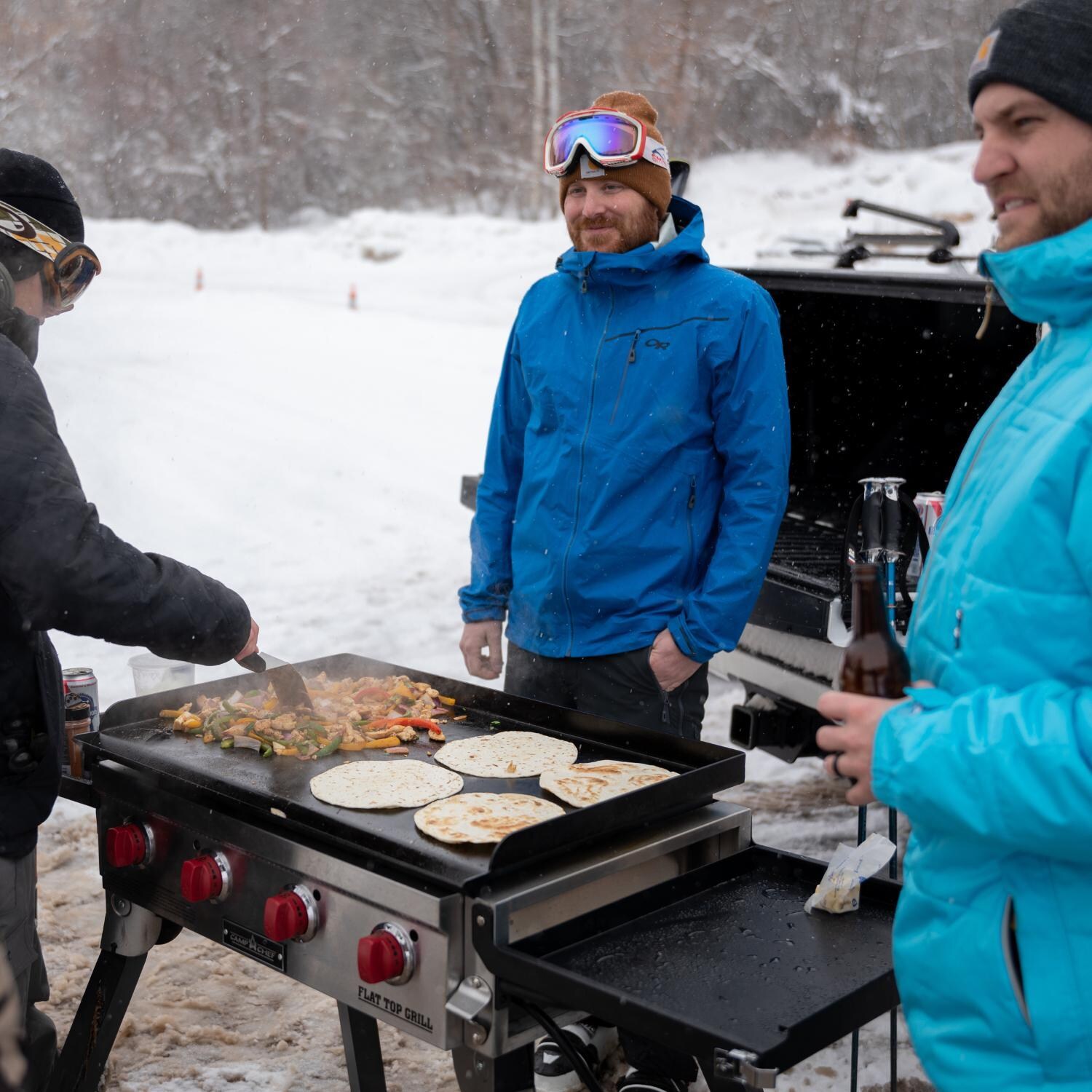 Camp Chef FTG600P 4-Burner Portable Flat Top Grill - Cooking During Ski Trip - Lifestyle thumbnail
