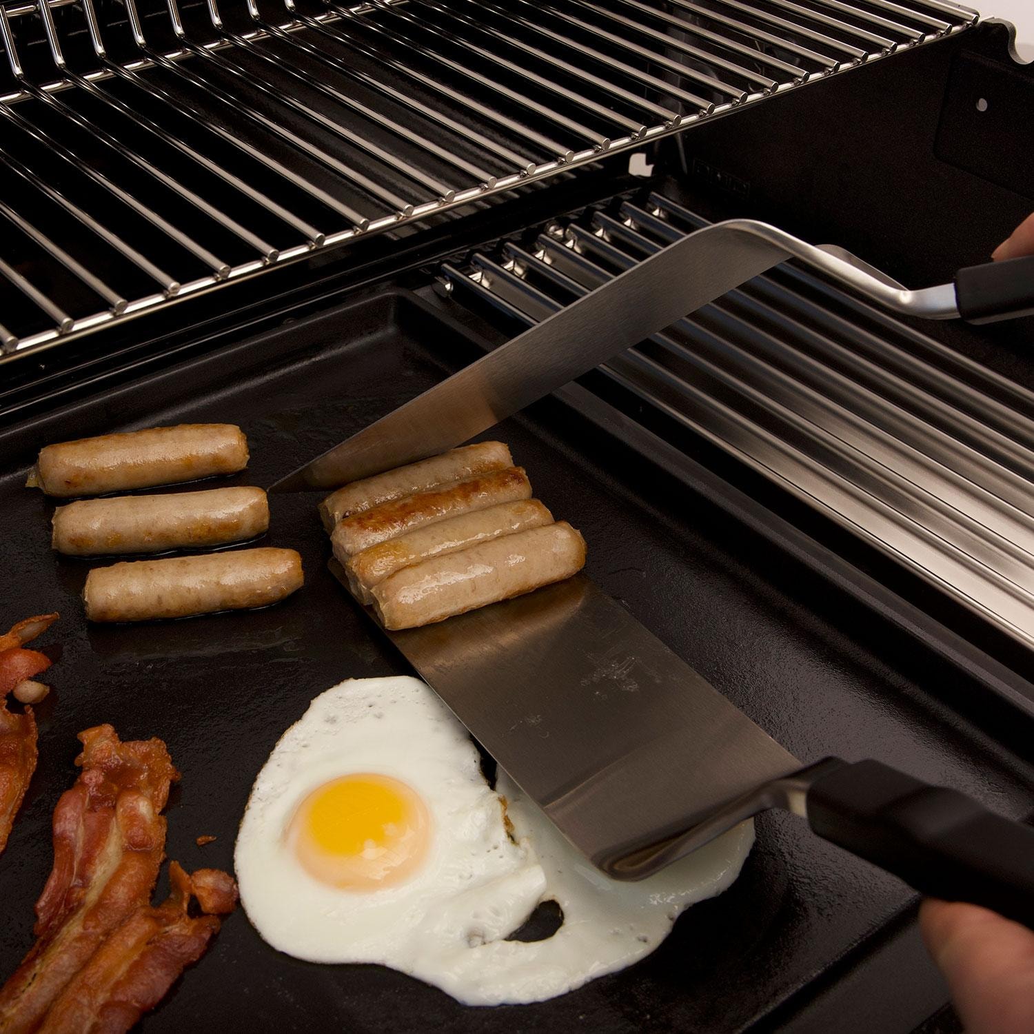 Broil King 11306 6 Pc Plancha Cooking Tool Set - Using Spatulas for Sausage Links - Lifestyle thumbnail