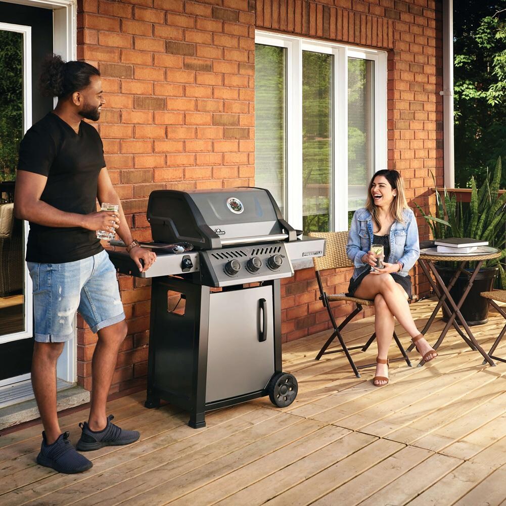 Napoleon F365DNGT Freestyle 365 3 Burner Natural Gas Grill - Graphite Grey - On Patio w/ People - Lifestyle thumbnail