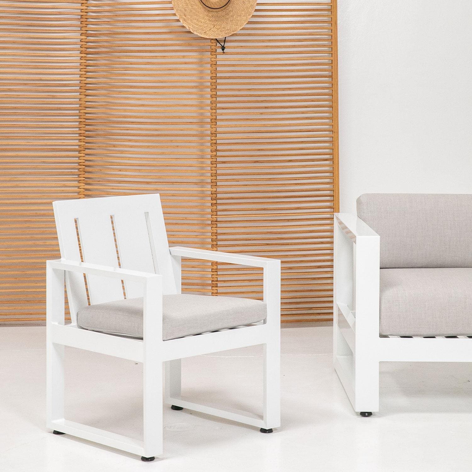 Newport Aluminum Dining Chair in Canvas Natural w/ No Welt by Sunset West - Styled W/ Privacy Screen Shown in Cast Silver Cushion Color finish (Only Dining Chair Included) - White Background thumbnail