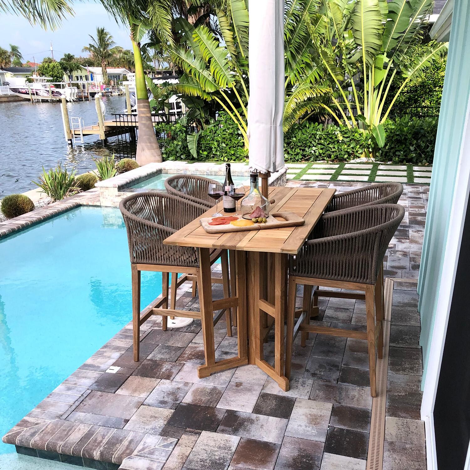 Royal Teak Collection BTDL64 Admiral 64 Inch Rectangular Teak Bar Table w/ Drop Leaf - Shown with Chairs (Sold Separately) - Lifestyle thumbnail