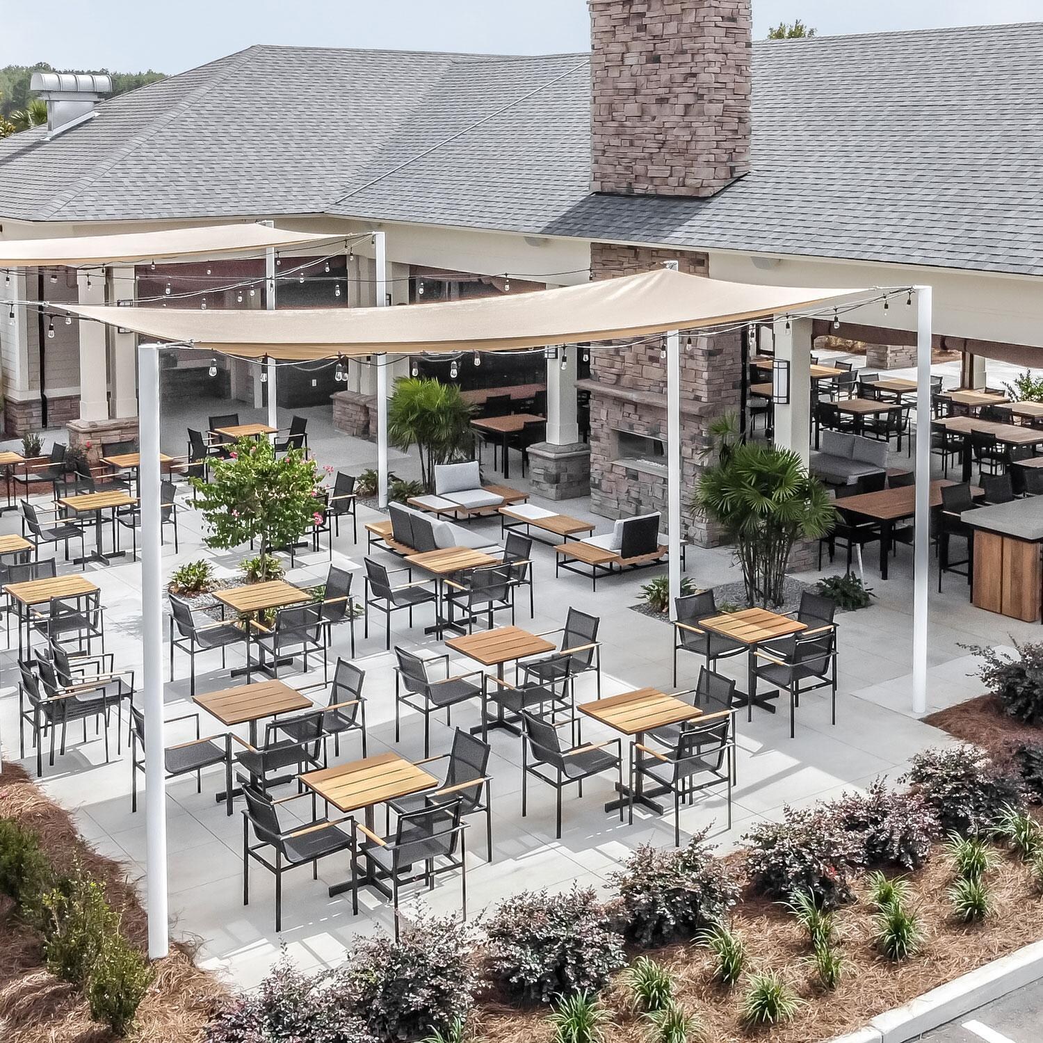 Teak + Table St Barts Aluminum Stacking Dining Chair in Black - Landscape View - Lifestyle thumbnail