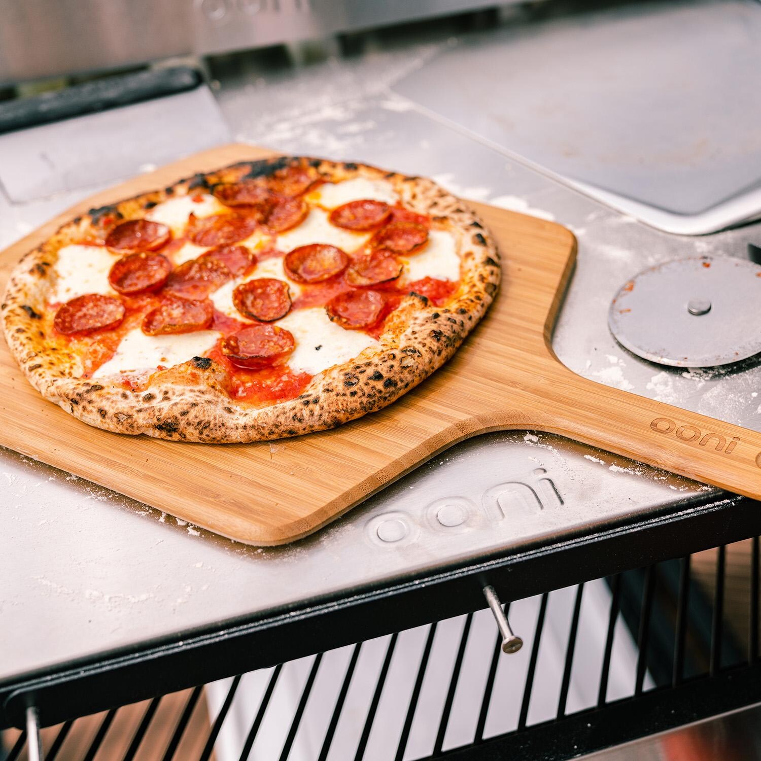 Ooni UU-P0B900 16-in Bamboo Peel & Serving Board - Pizza - Lifestyle thumbnail