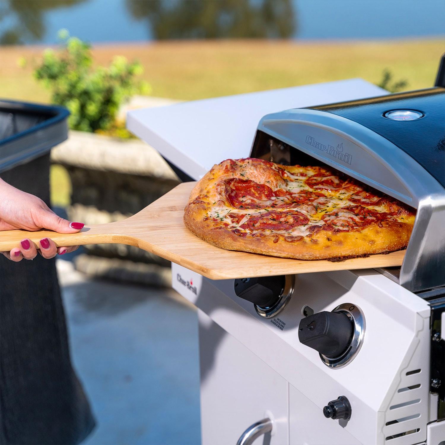 Charbroil 2415977 Universal Pizza Oven Grill Accessory - Removing Baked Pizza on Grill - Lifestyle thumbnail