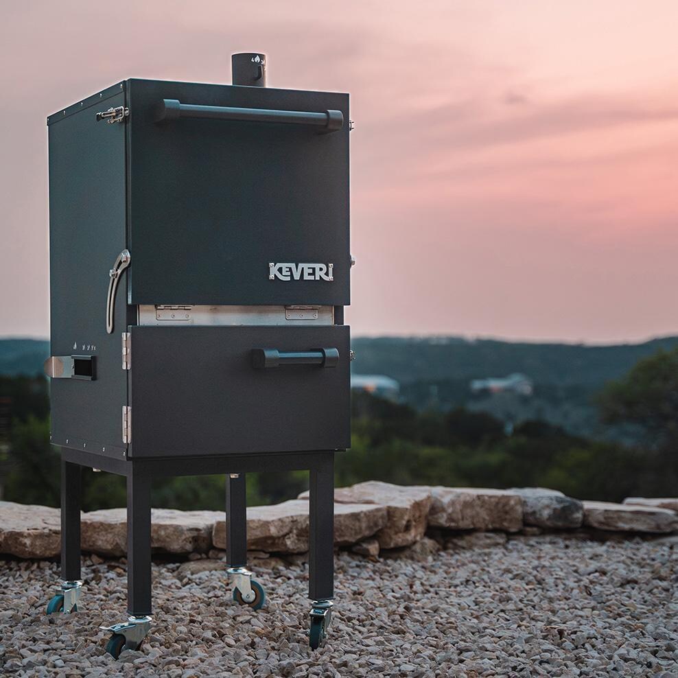 Keveri H1 H1BT Vertical Multi-Purpose Charcoal Oven - Black Truffle - Angle in Front of Sun - Lifestyle thumbnail