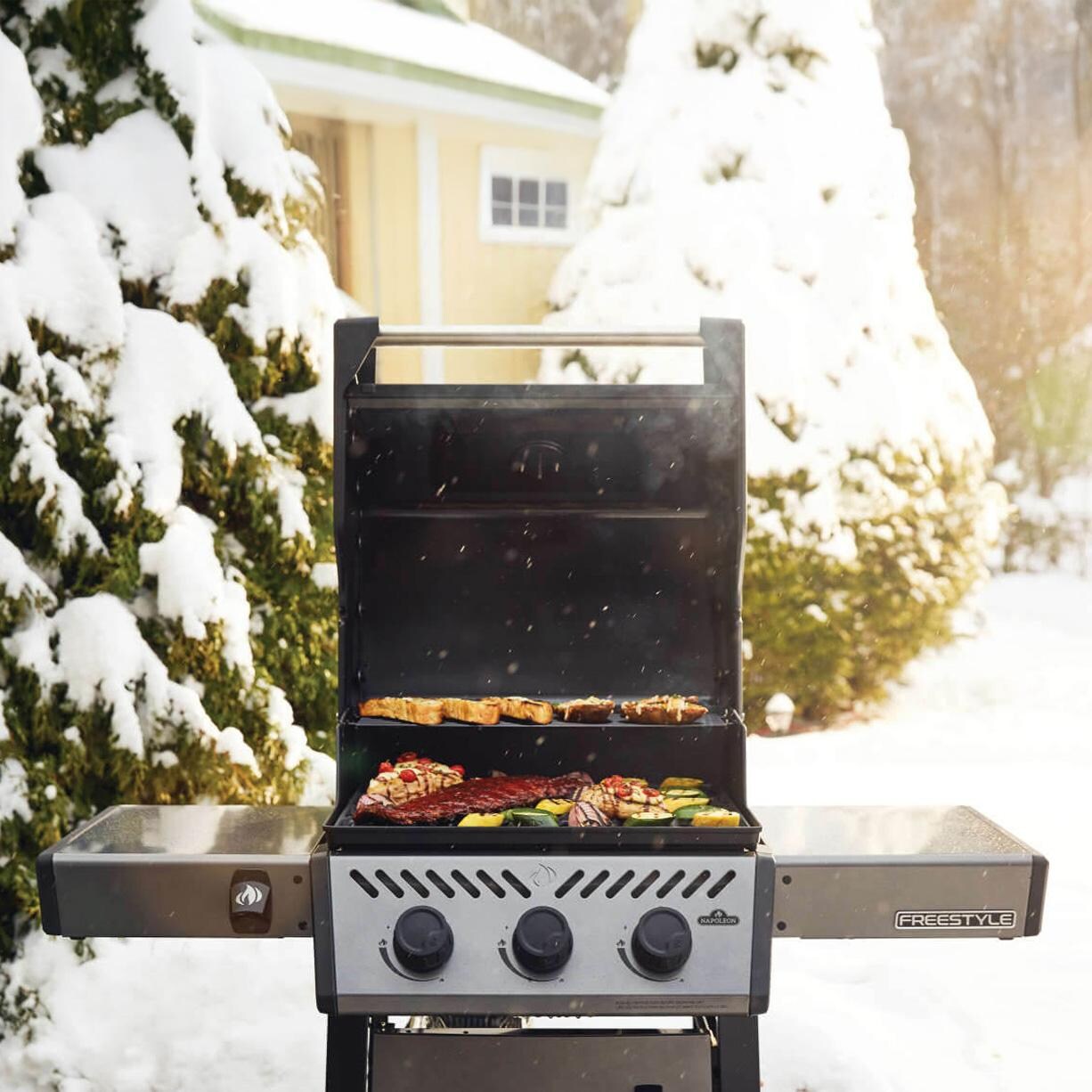 Napoleon F365DPGT Freestyle 365 3 Burner Propane Gas Grill - Graphite Grey - Cooking in Snow - Lifestyle thumbnail