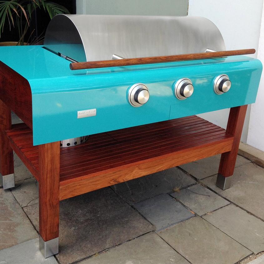 Rockwell By Caliber 60-Inch Natural Gas Grill On Wood Table - Turquoise