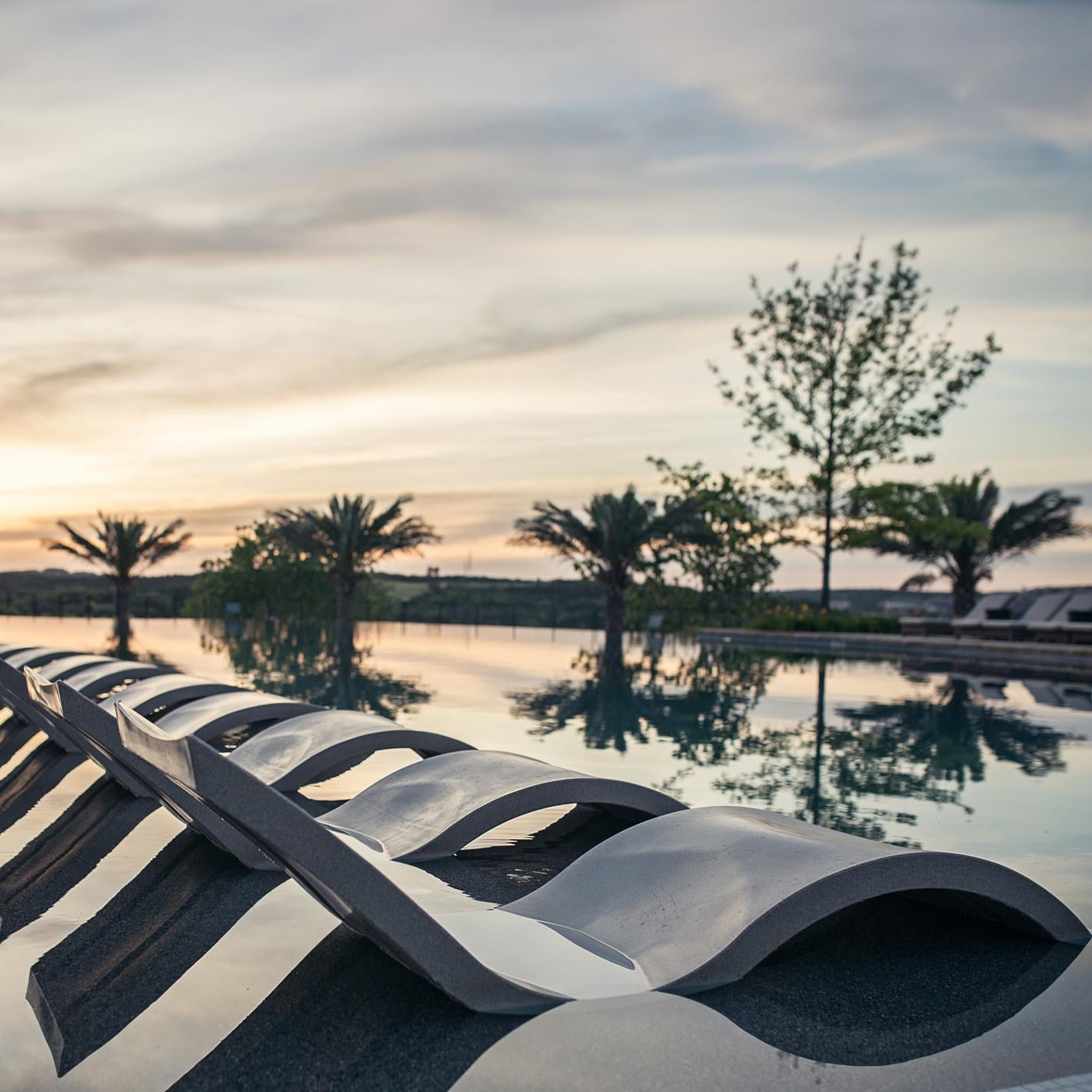 Ledge Lounger Signature In Pool Chaise Lounge - Dark Blue - Shown in Gray - Lifestyle thumbnail