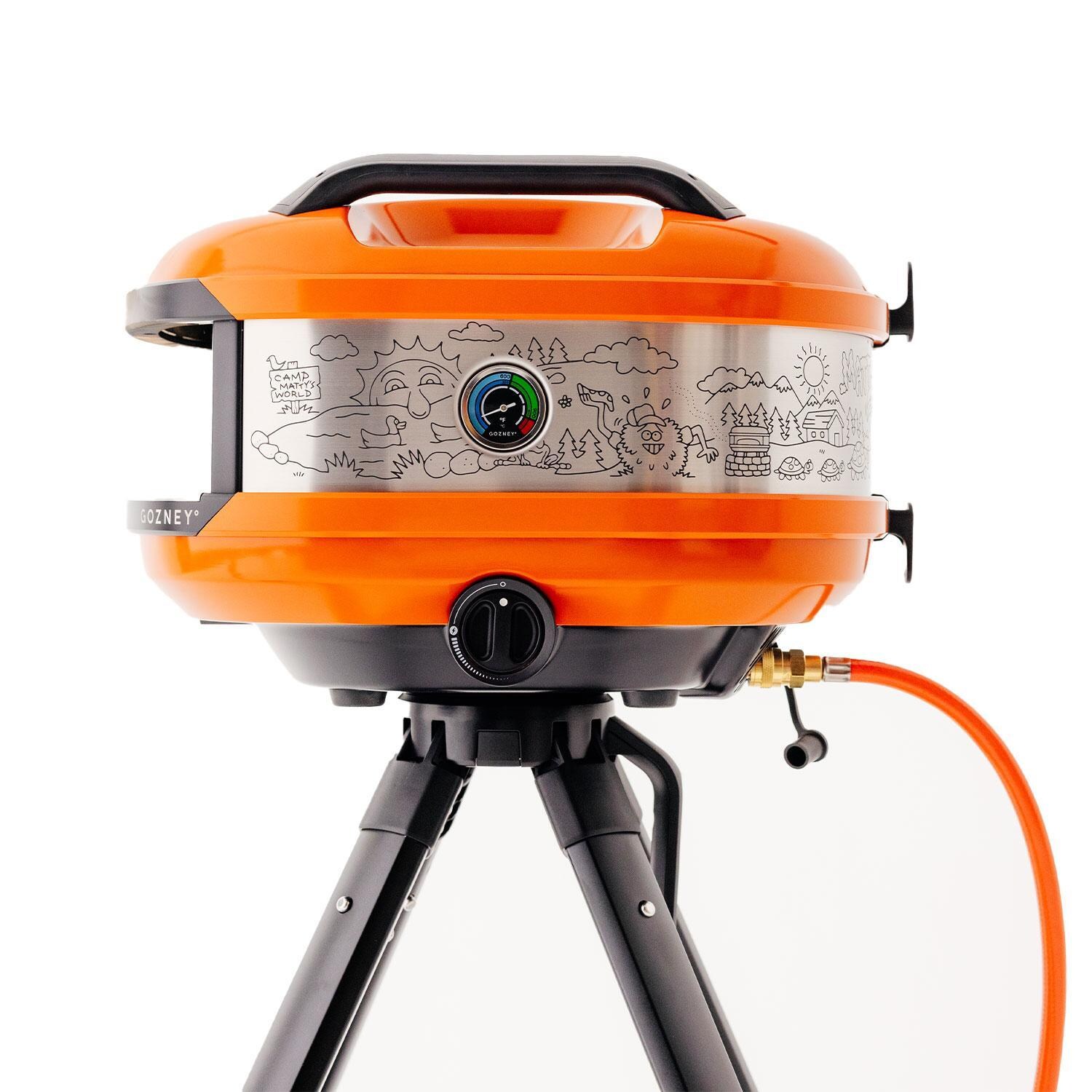 Matty Matheson x Gozney GTPOGUS1225 Limited-Edition Tread Portable Propane Pizza Oven - Orange - On Tread Stand - Side View - White Background thumbnail