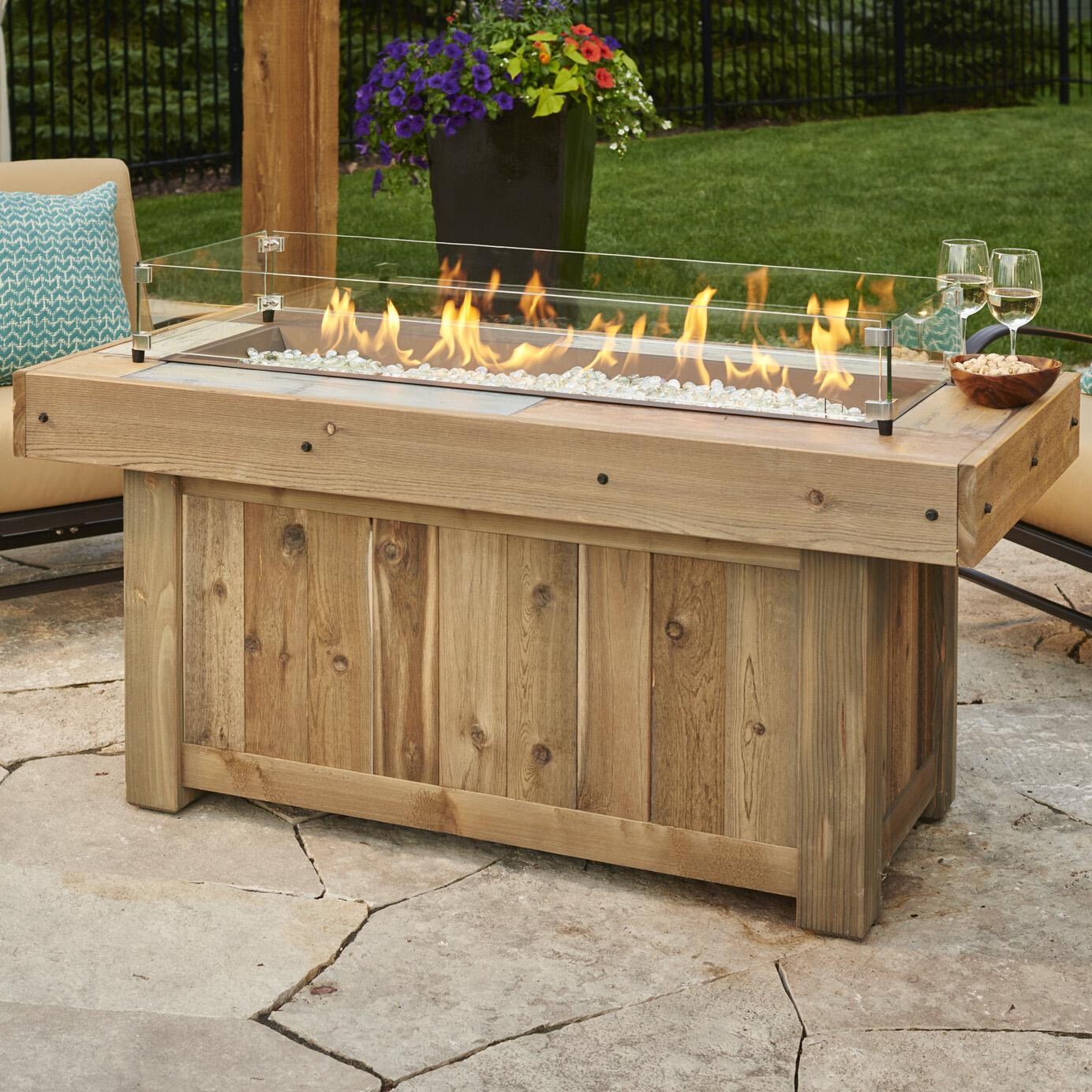 The Outdoor GreatRoom Company Vintage Linear Gas Fire Pit Table - Brown - Lifestyle - Glass wind guard pictured is optional accessory thumbnail