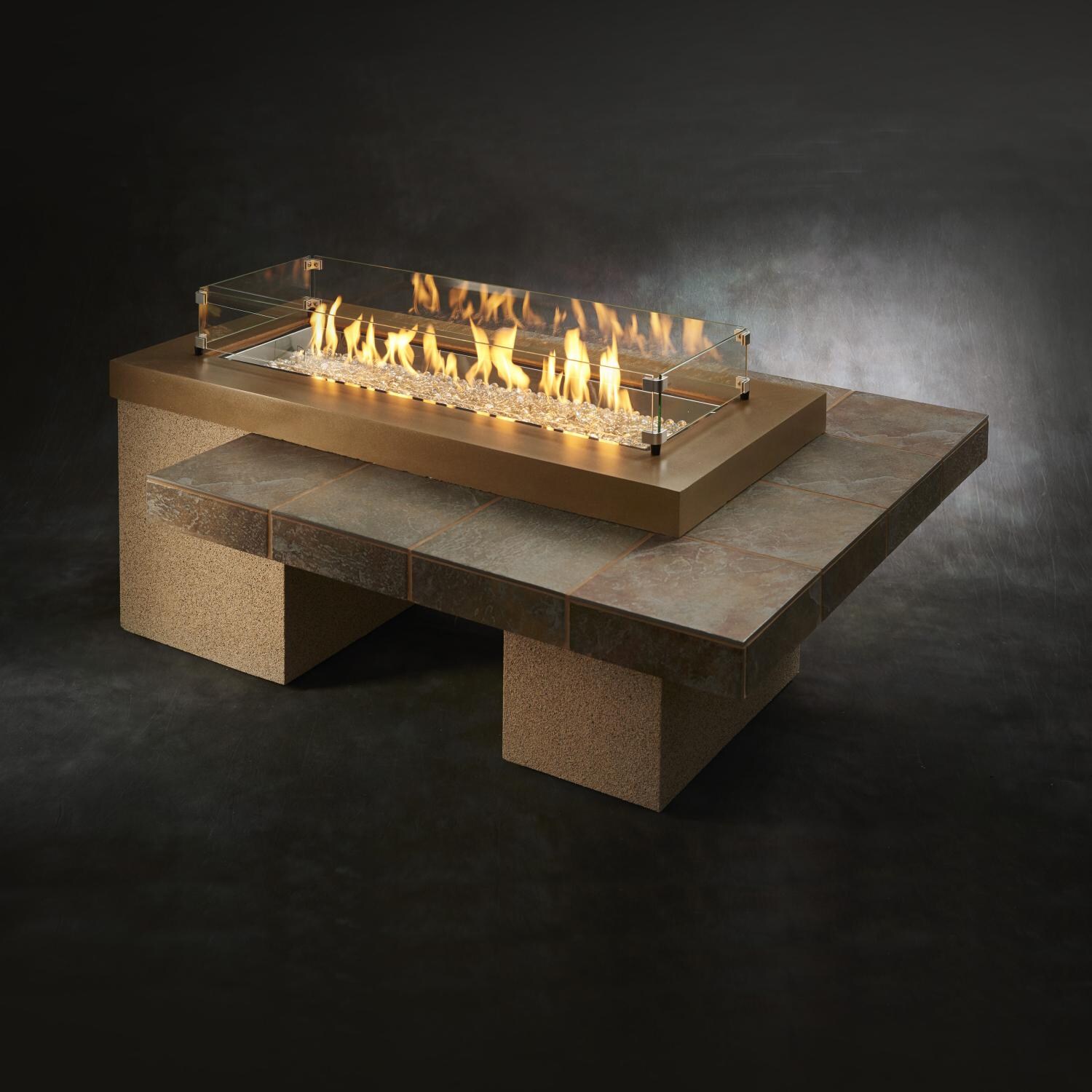 The Outdoor GreatRoom Company Uptown Linear Gas Fire Pit Table - Brown - Lifestyle - Glass wind guard pictured is optional accessory thumbnail