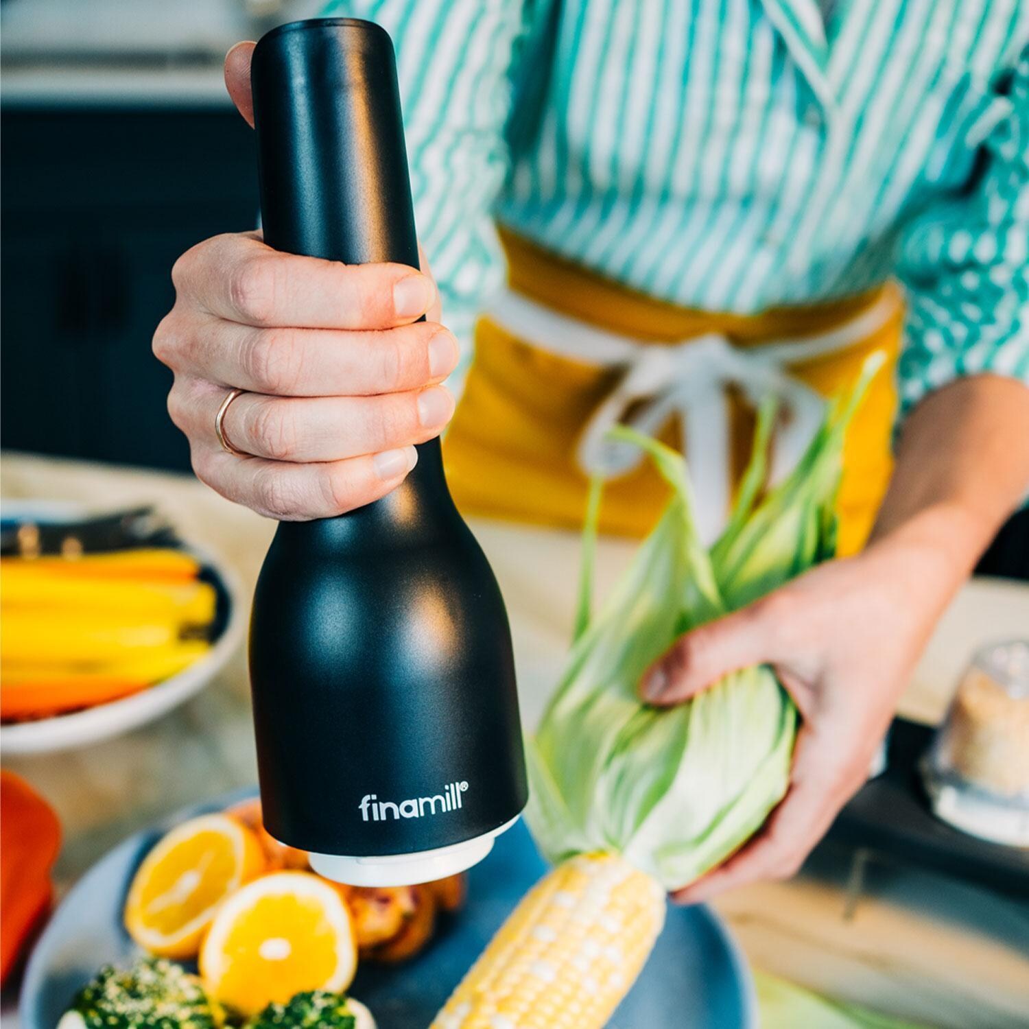 FinaMill GP813437-111MIB Classic Rechargeable Spice Grinder in Midnight Black w/ 1 Everyday Pod & 1 Peppercorn Pod - In Use - Lifestyle thumbnail