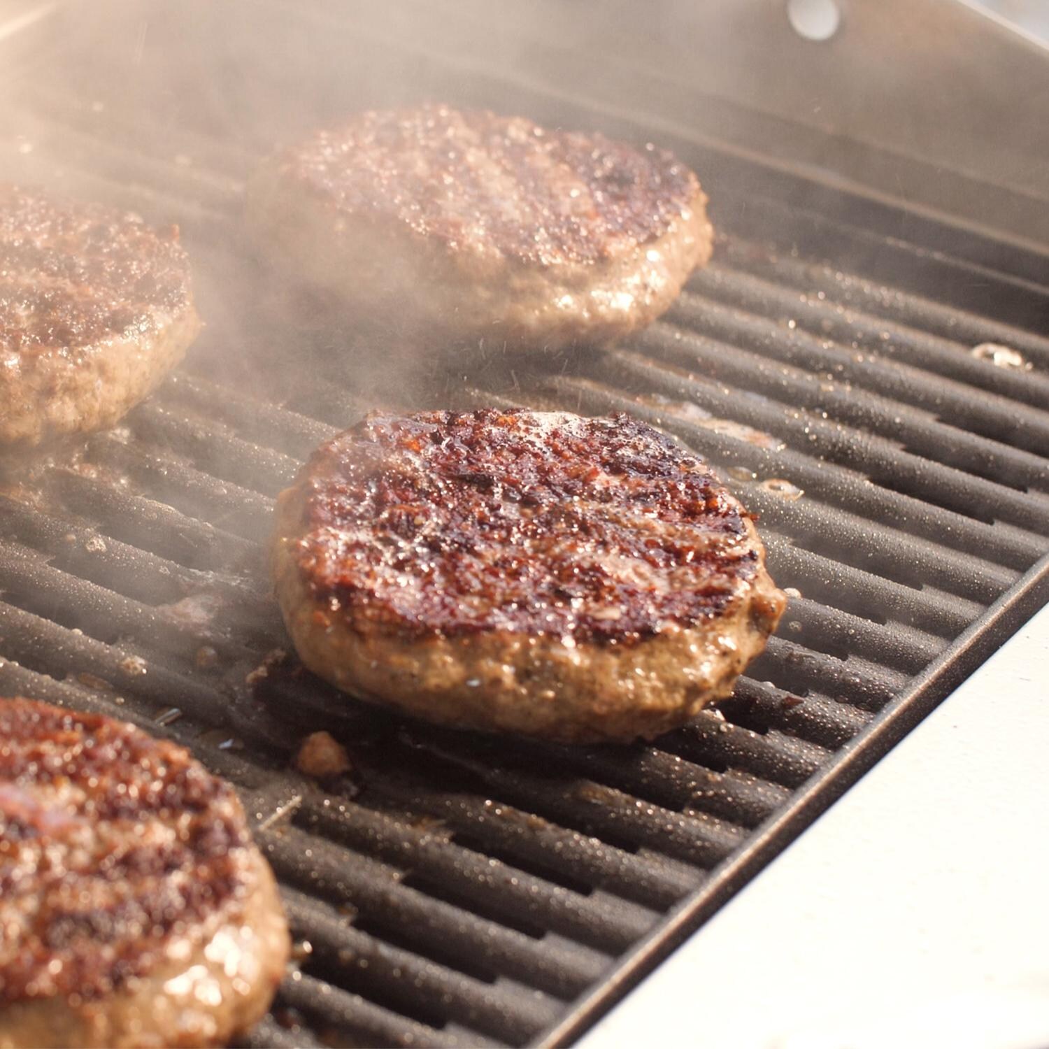 Coyote 18-Inch Built-In / Portable Electric Grill On Patio Post - Grilling Burgers thumbnail