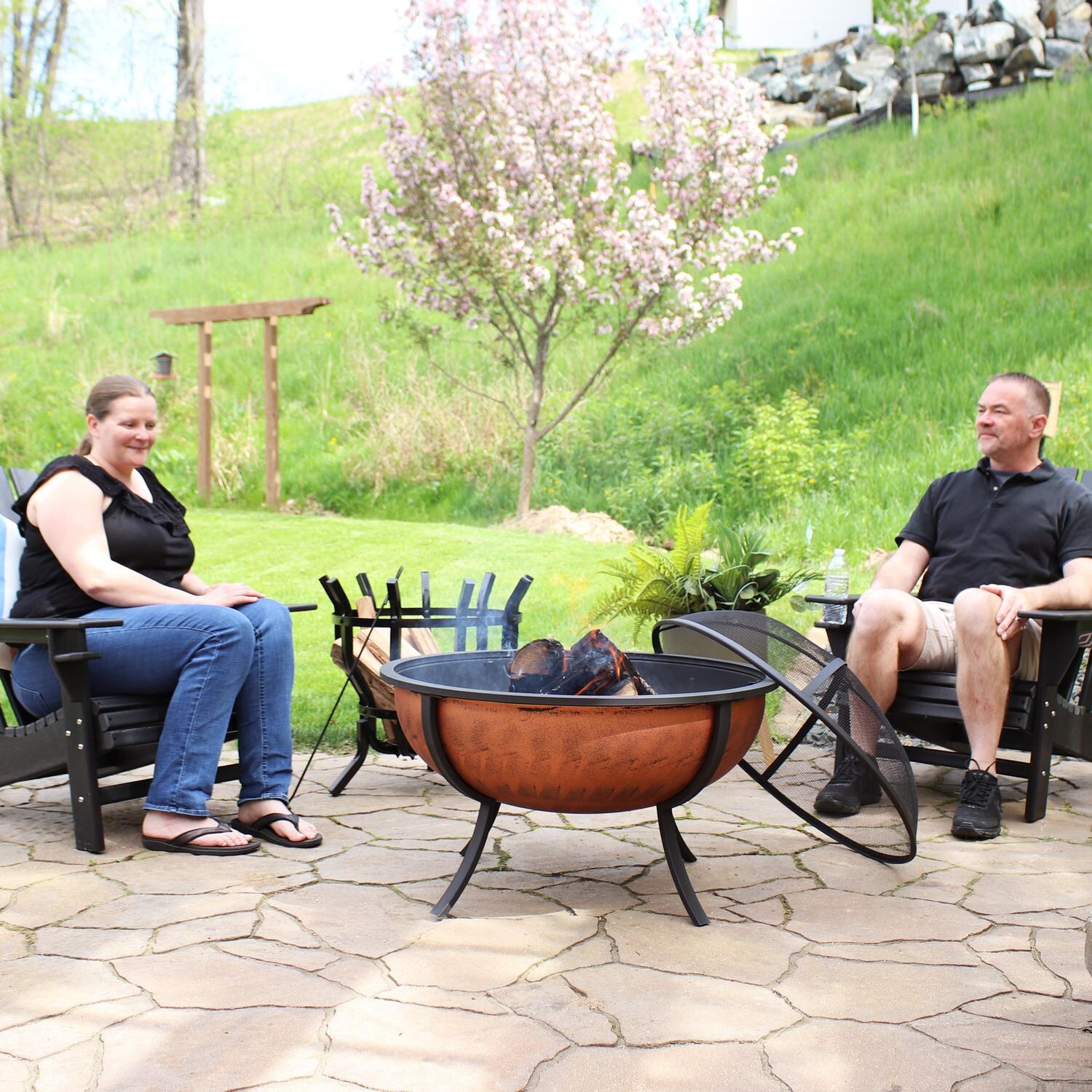 Ultimate Patio NB-550 32 Inch Round Steel Wood-Burning Fire Pit in Copper - People Enjoying Backyard Fire - Lifestyle thumbnail